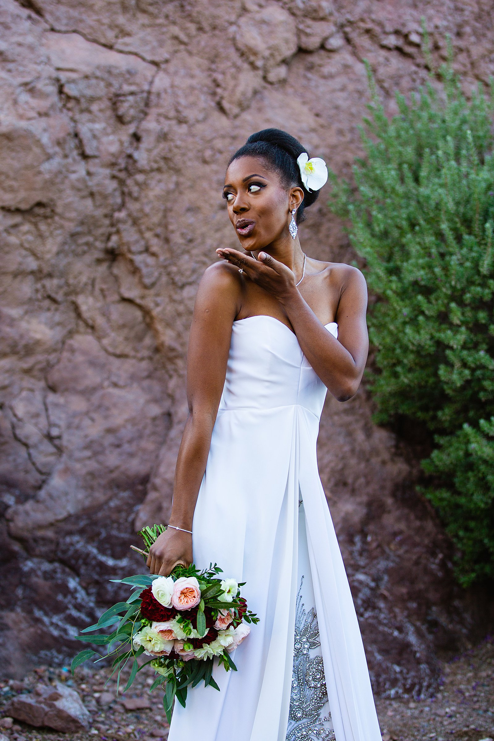 Bride blowing a kiss in her wedding dress for her multicultural wedding by PMA Photography.