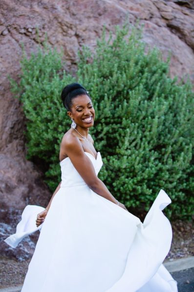 Bride playing with her dress during her multicultural wedding by Arizona wedding photographer PMA Photography.
