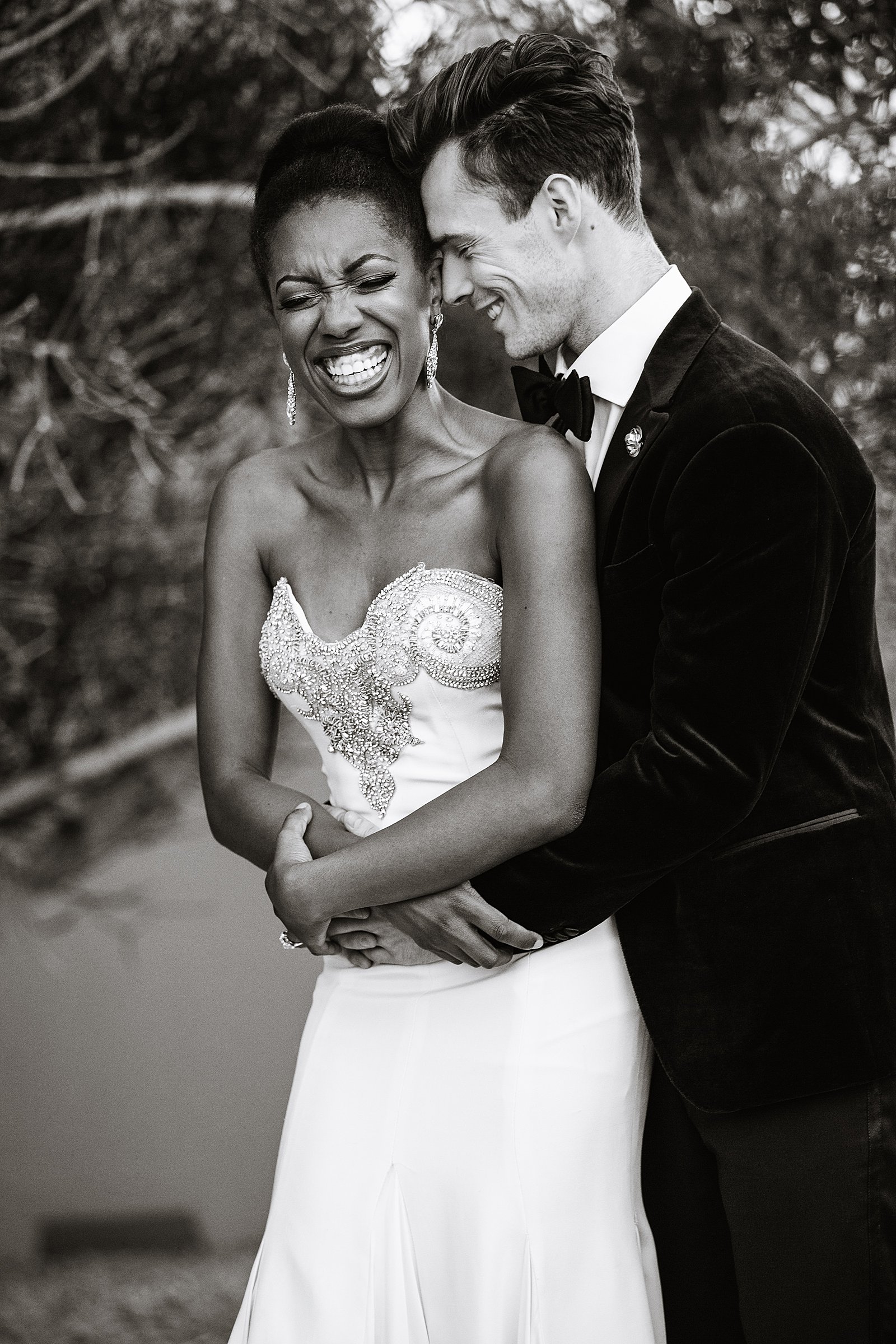 Bride and Groom laughing together during their multicultural wedding by Phoenix wedding photographer PMA Photography.