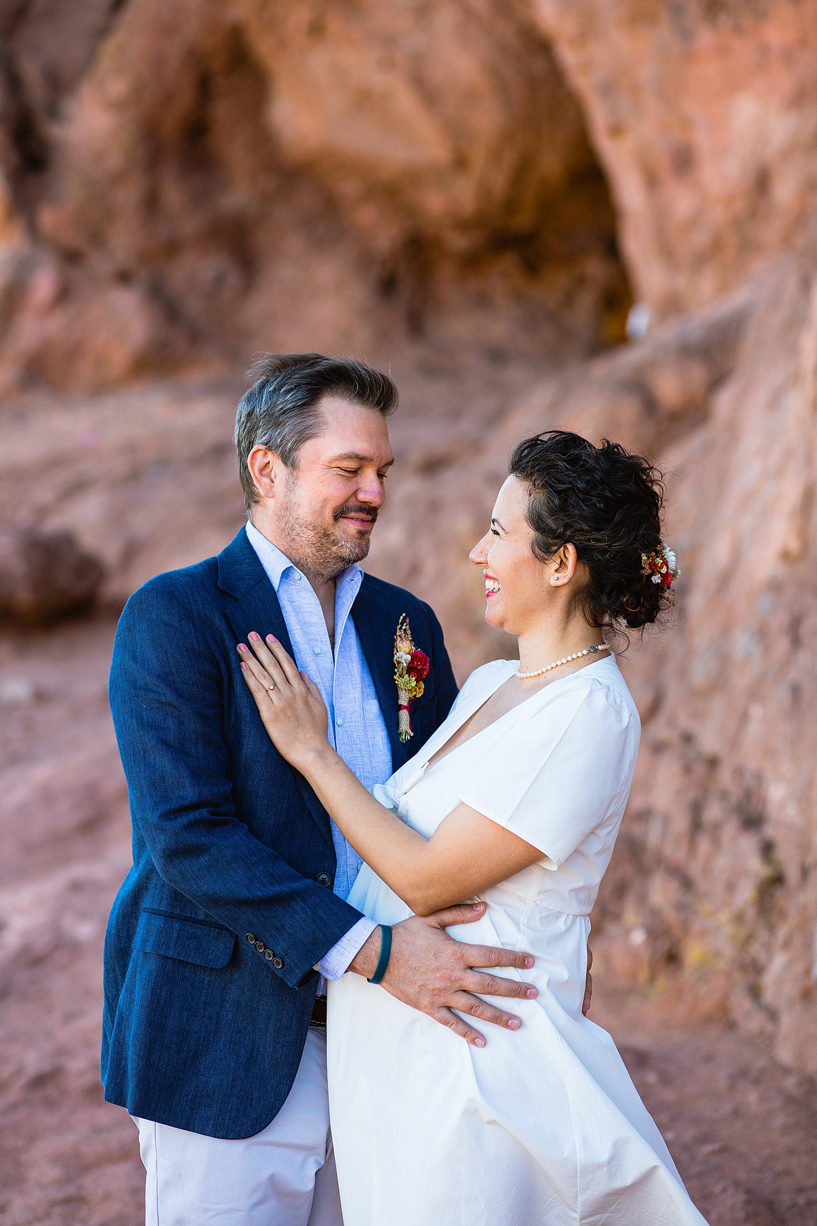 Bride and Groom laughing together during their Papago Park elopement by Arizona elopement photographer PMA Photography.
