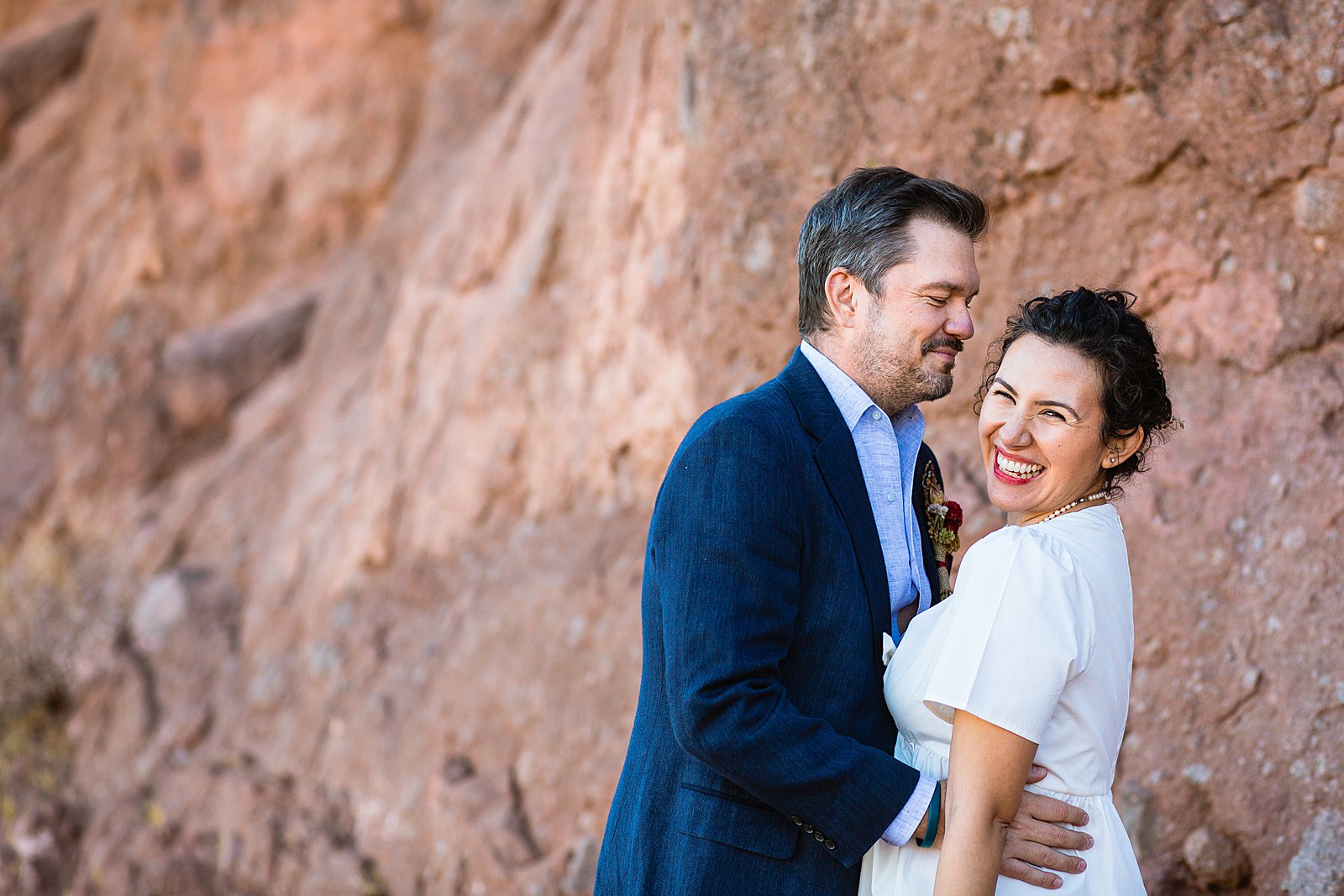 Bride and Groom laughing together during their Papago Park elopement by Phoenix elopement photographer PMA Photography.