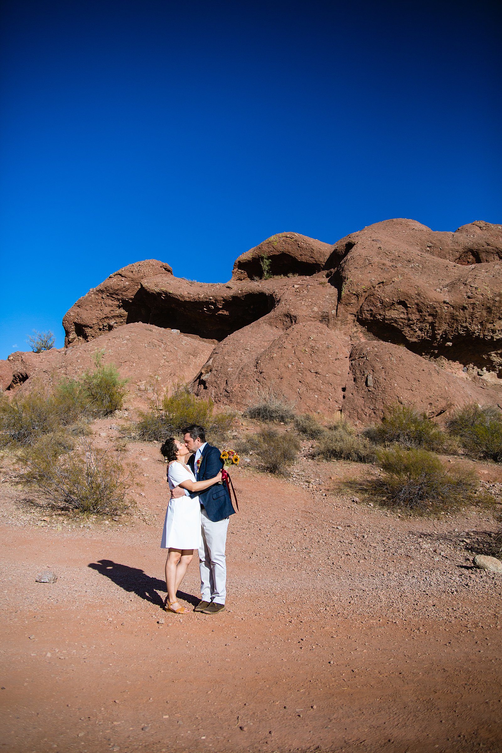 Bride and Groom share a kiss during their Papago Park elopement by Phoenix elopement photographer PMA Photography.
