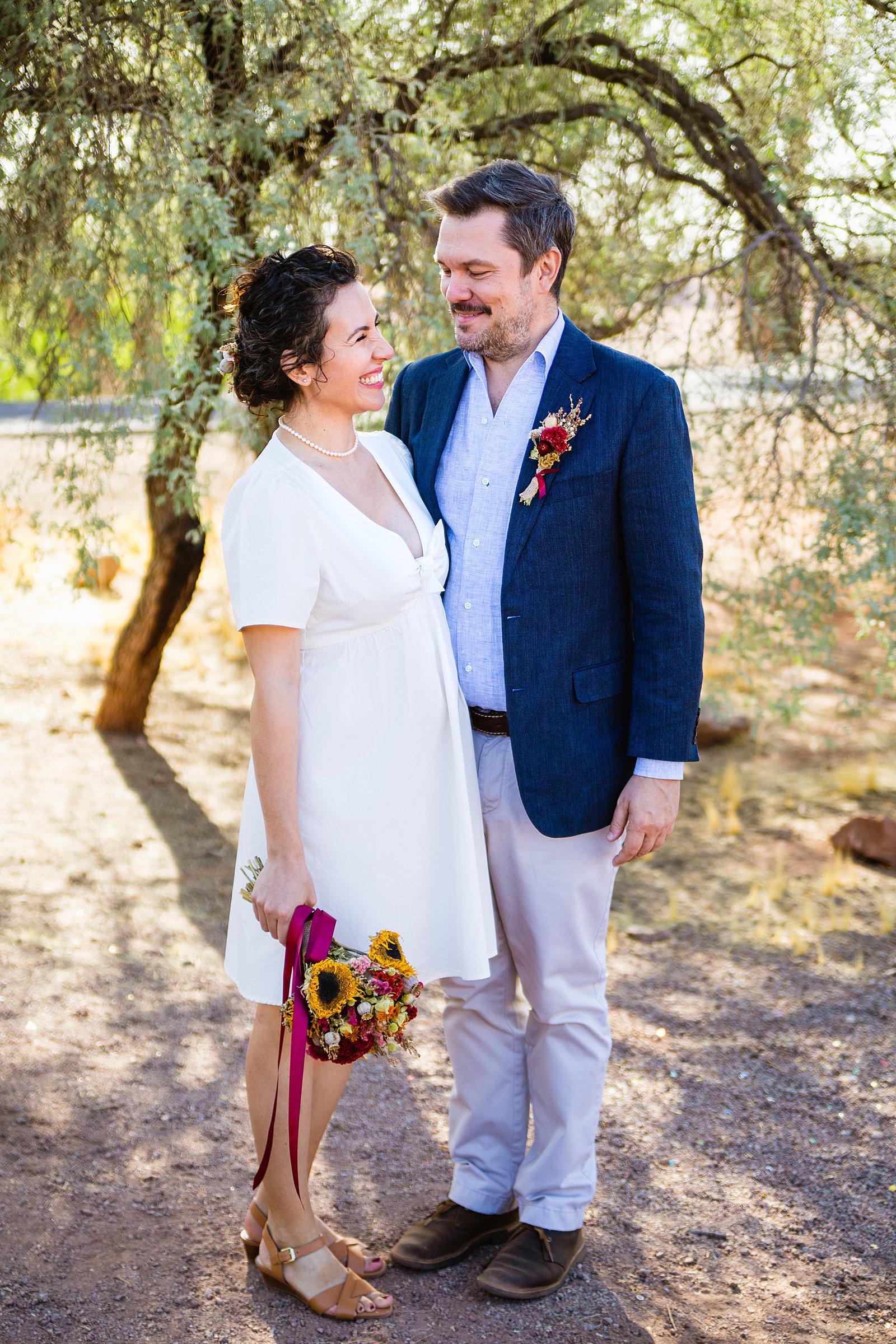 Bride and Groom laughing together during their Papago Park elopement by Phoenix elopement photographer PMA Photography.