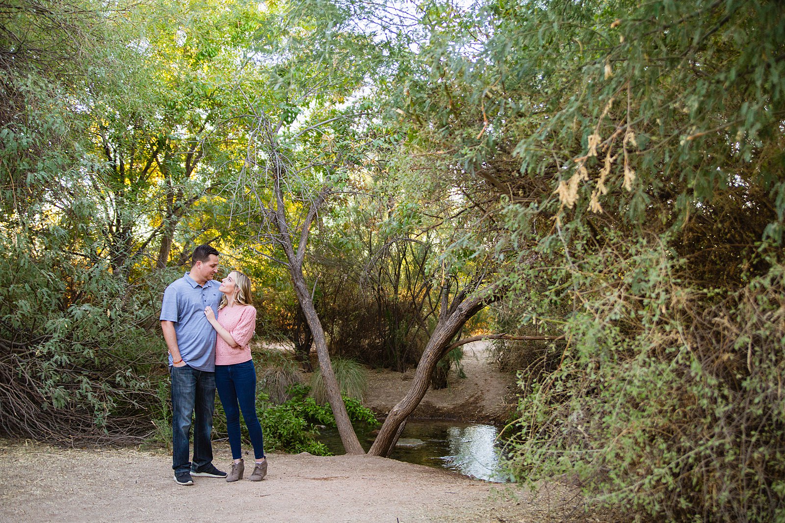 Couple pose for their Riparian Preserve at Water Ranch engagement session by Gilbert wedding photographer PMA Photography.