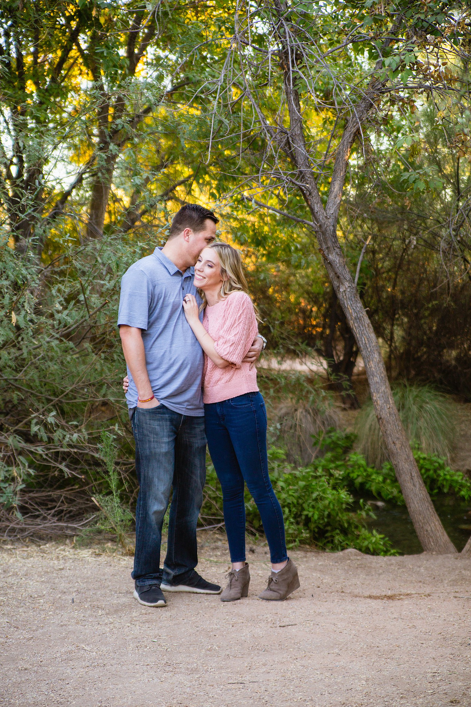Couple laugh together during their Gilbert engagement session by Arizona engagement photographer PMA Photography.