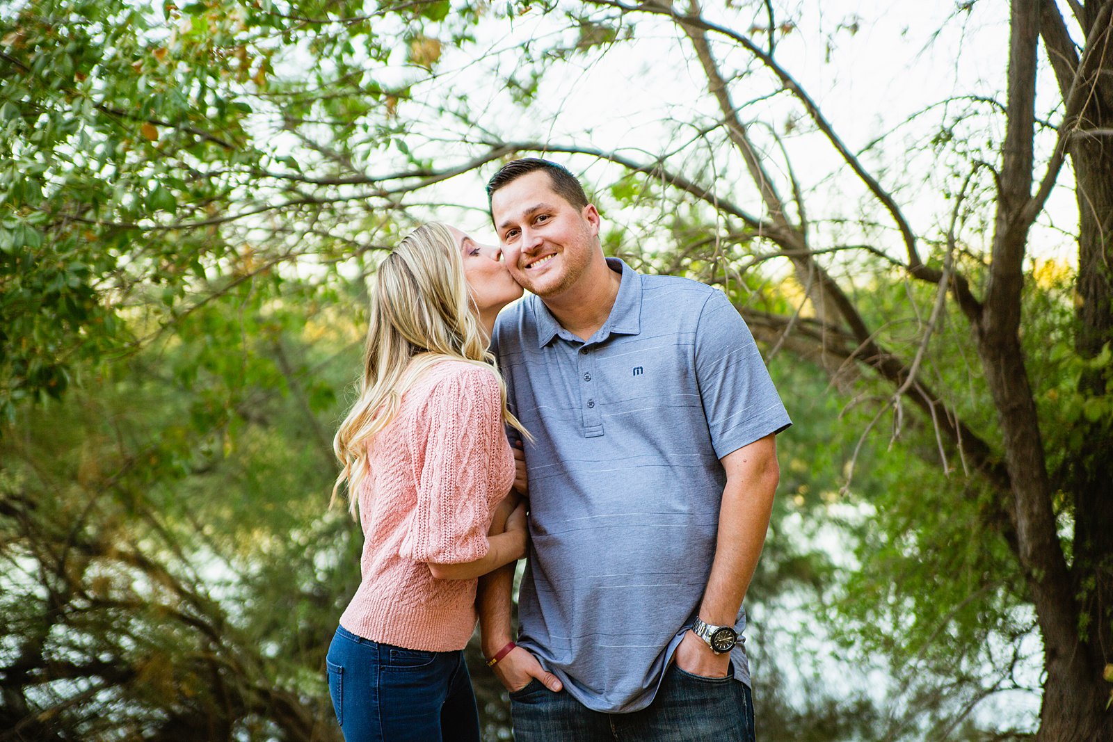 Couple share a kiss during their Riparian Preserve at Water Ranch engagement session by Gilbert wedding photographer PMA Photography.