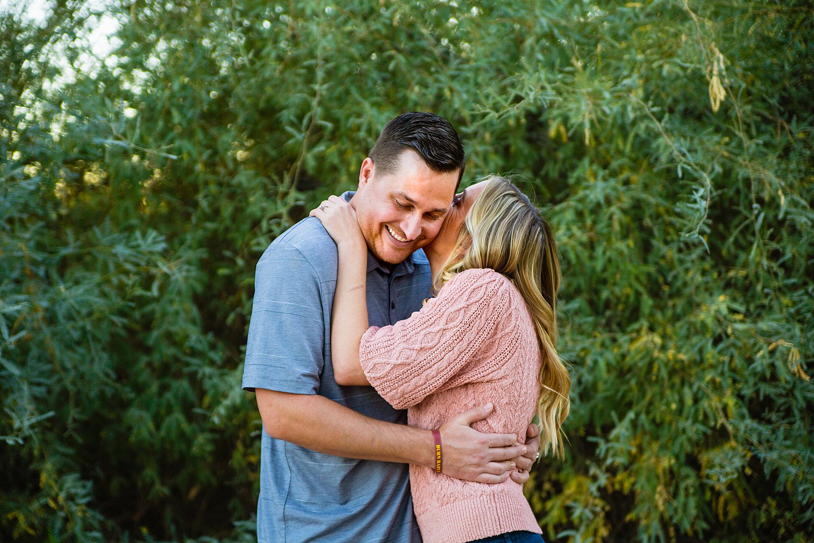 Couple laugh together during their Riparian Preserve at Water Ranch engagement session by Gilbert engagement photographer PMA Photography.