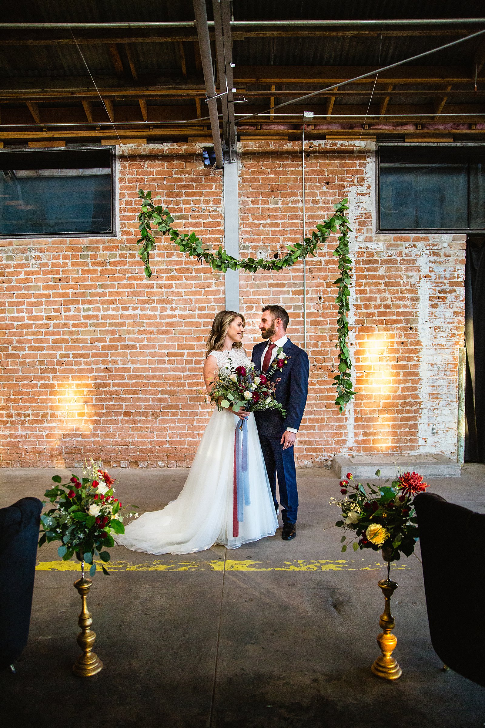 Bride and Groom pose for their Sunkist Warehouse wedding by Mesa wedding photographer PMA Photography.