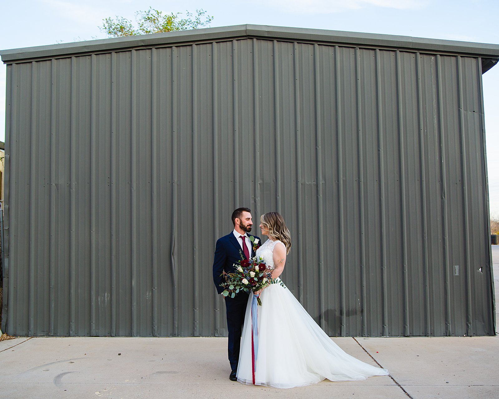 Bride and Groom pose for their Sunkist Warehouse wedding by Mesa wedding photographer PMA Photography.