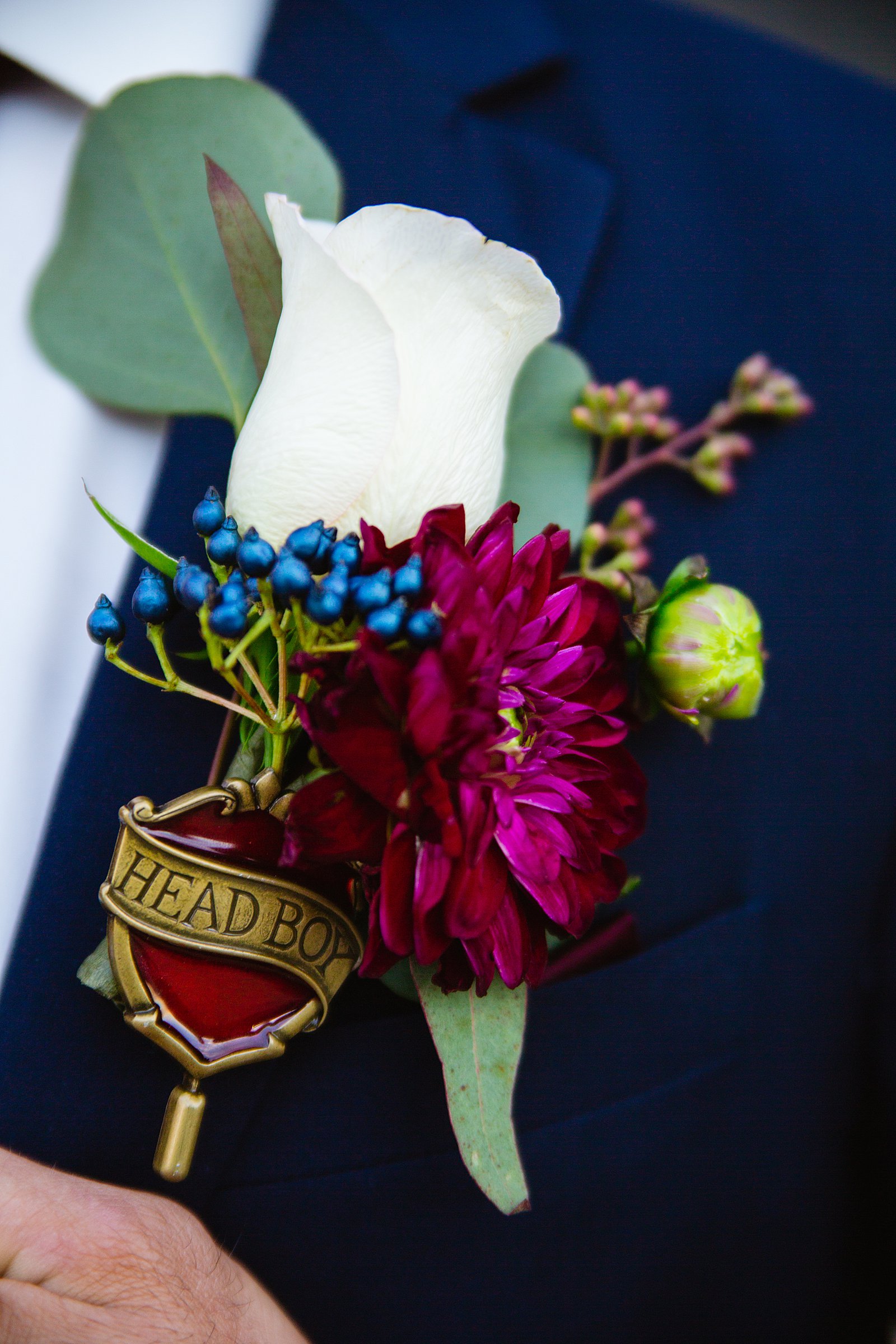 Groom's jewel toned Harry Potter inspired boutonniere by PMA Photography.