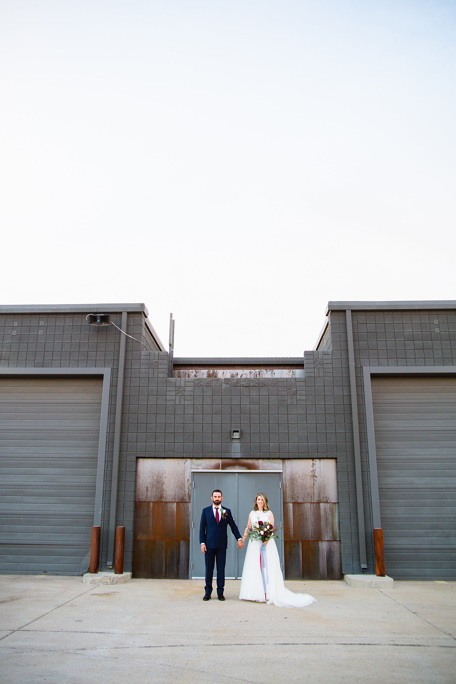 Bride and Groom pose during their Sunkist Warehouse wedding by Arizona wedding photographer PMA Photography.