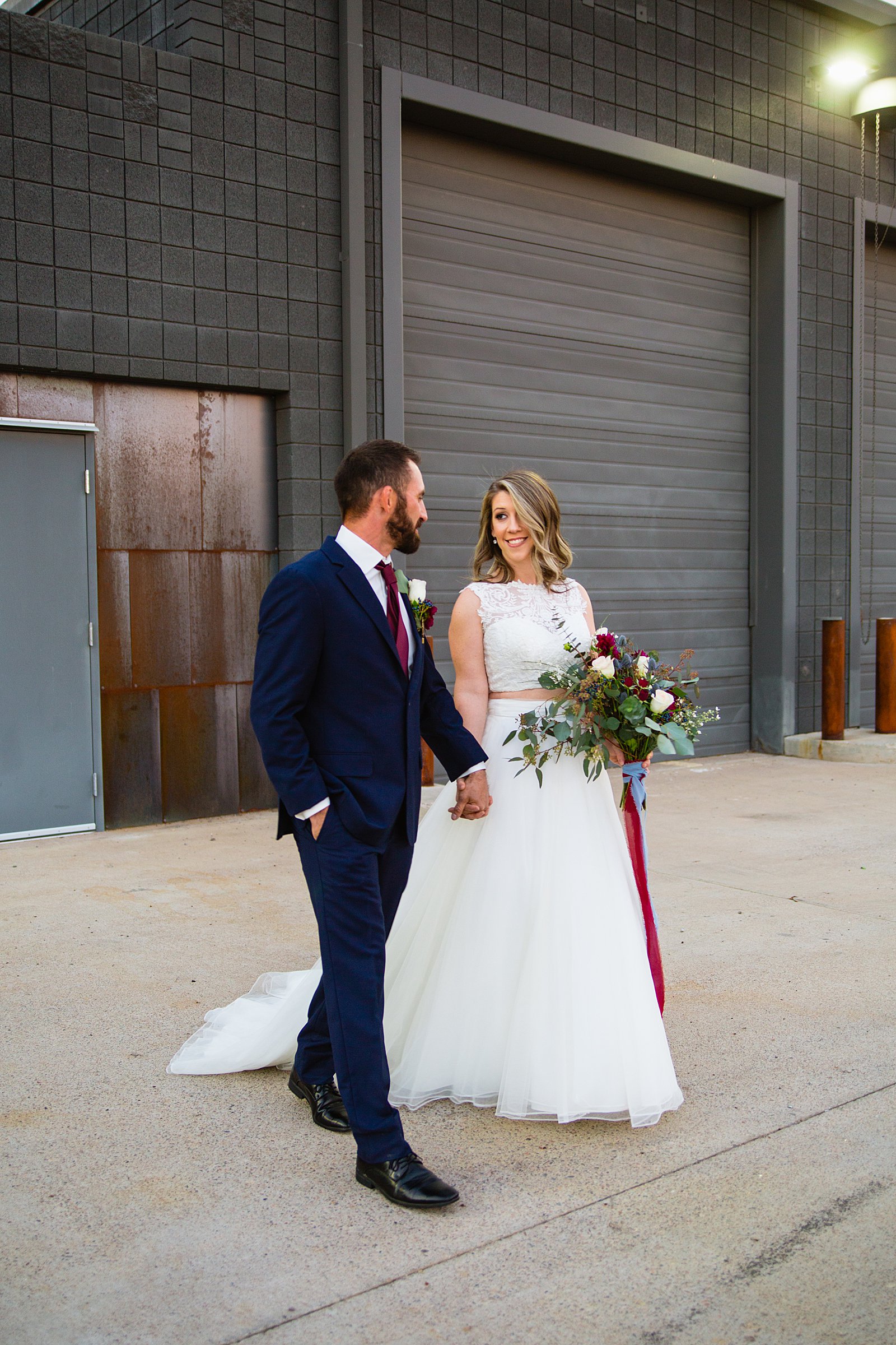 Bride and Groom walking together during their Sunkist Warehouse wedding by Mesa wedding photographer PMA Photography.