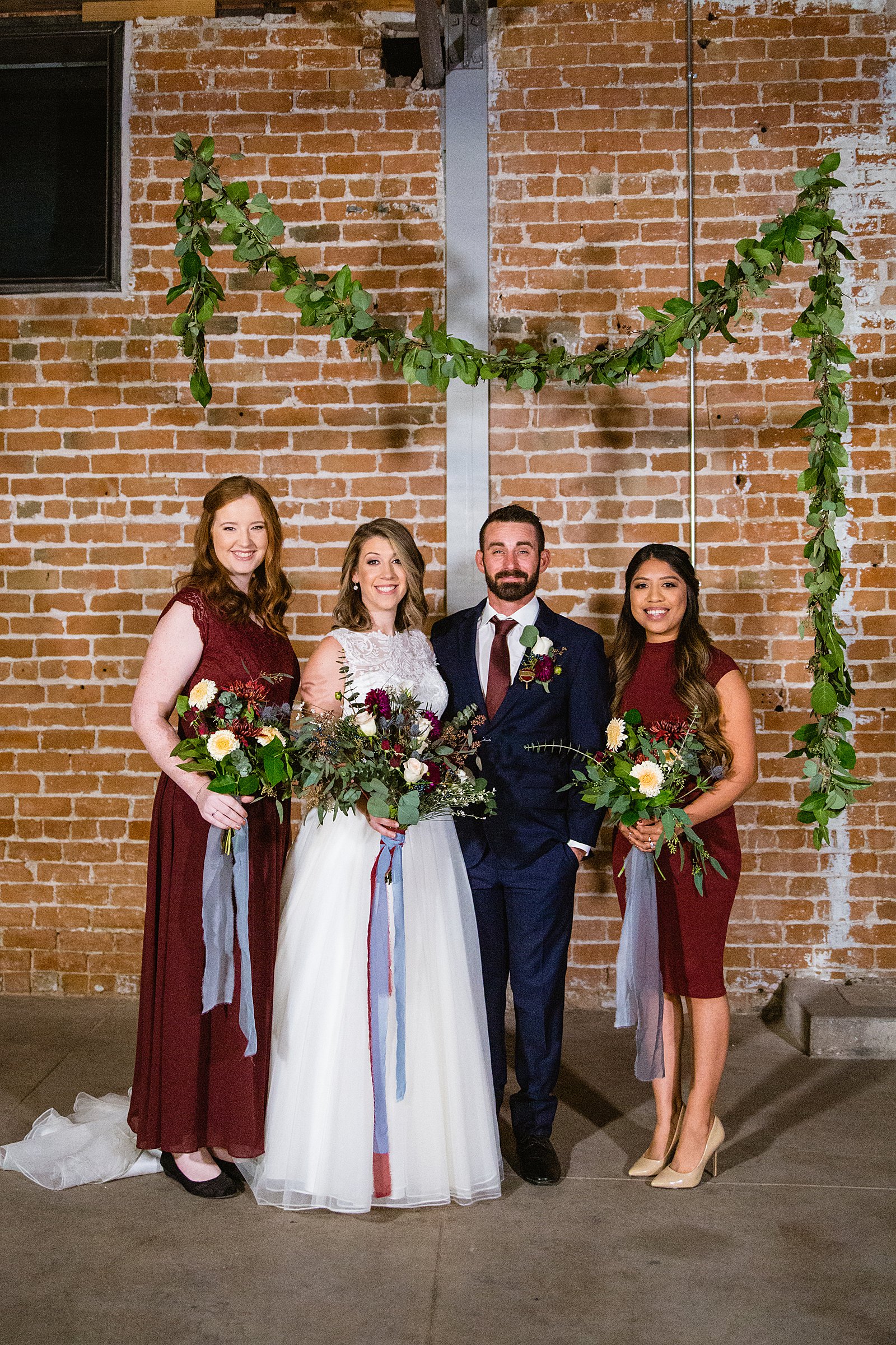 Bridal party together at a Sunkist Warehouse wedding by Arizona wedding photographer PMA Photography.