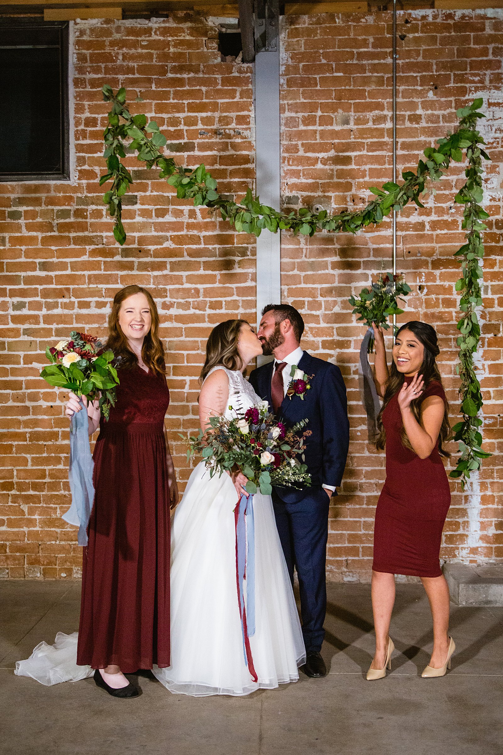 Bridal party having fun together at Sunkist Warehouse weding by Arizona wedding photographer PMA Photography.