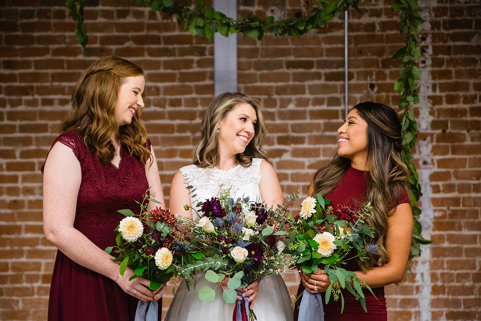 Bridal party laughing together at Sunkist Warehouse wedding by Mesa wedding photographer PMA Photography.