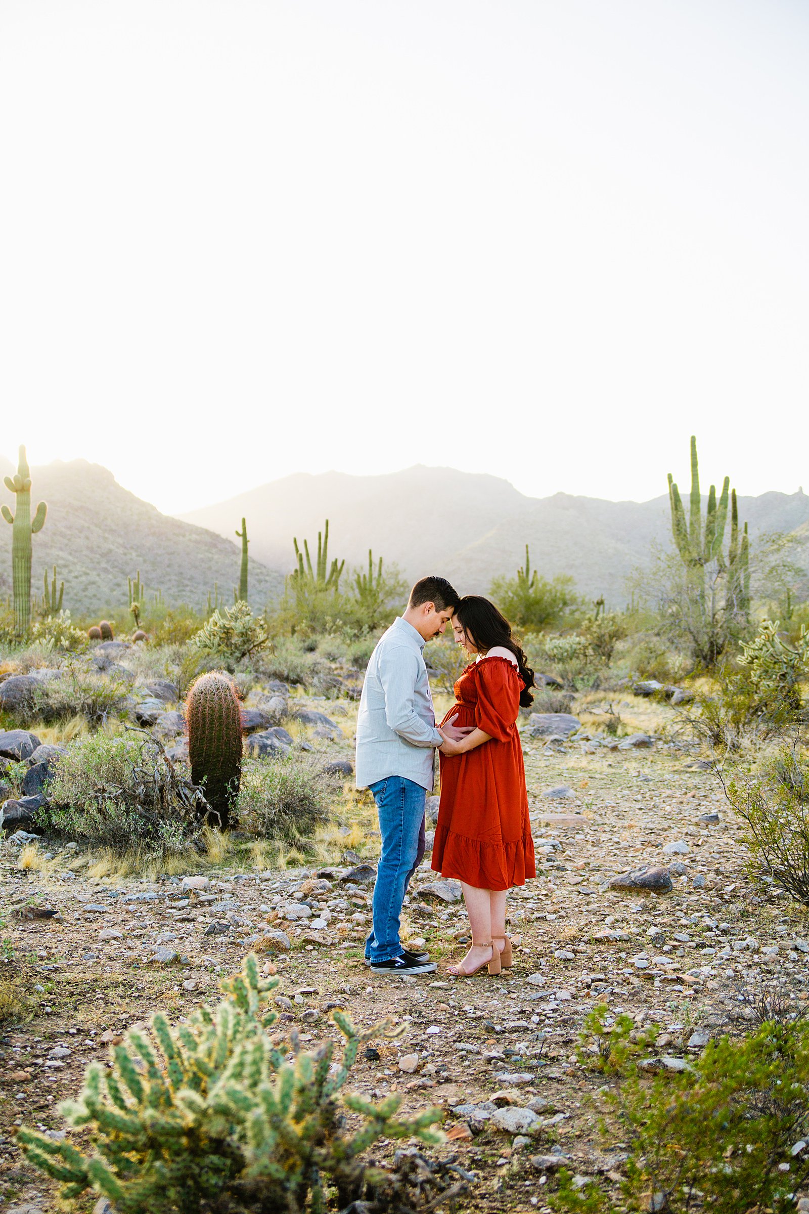 Couple pose for their White Tanks maternity session by Phoenix wedding photographer PMA Photography.