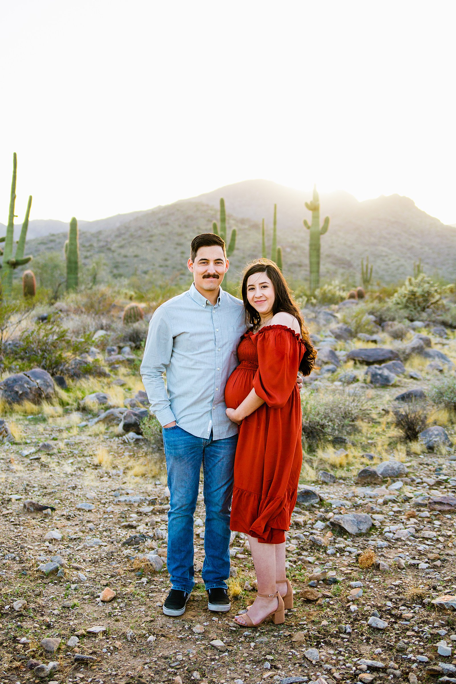 Couple pose for their White Tanks maternity session by Phoenix wedding photographer PMA Photography.