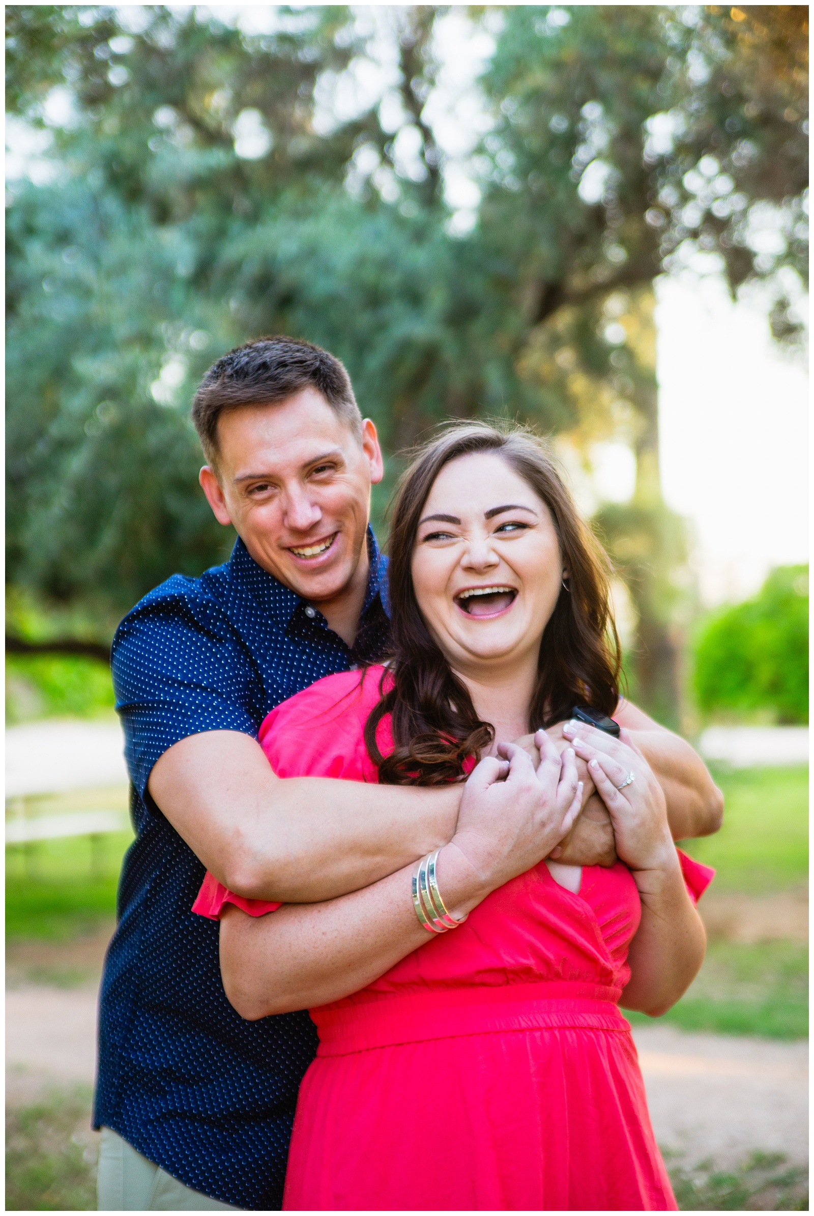 Couple laugh together during their Sahuaro Ranch engagement session by Glendale engagement photographer PMA Photography.