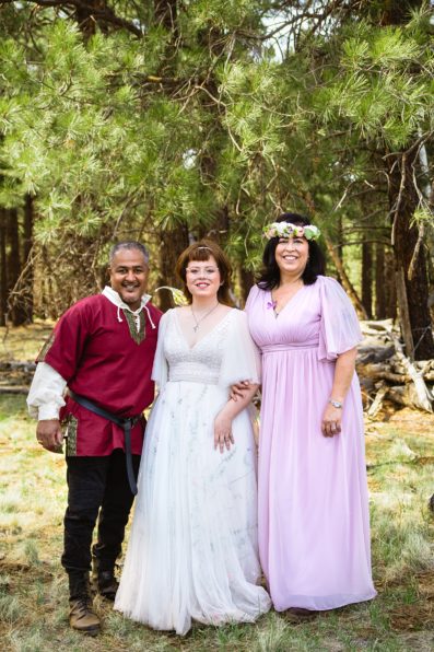 Newlyweds pose with their family at renaissance inspired wedding at Arizona Nordic Village by PMA Photography.