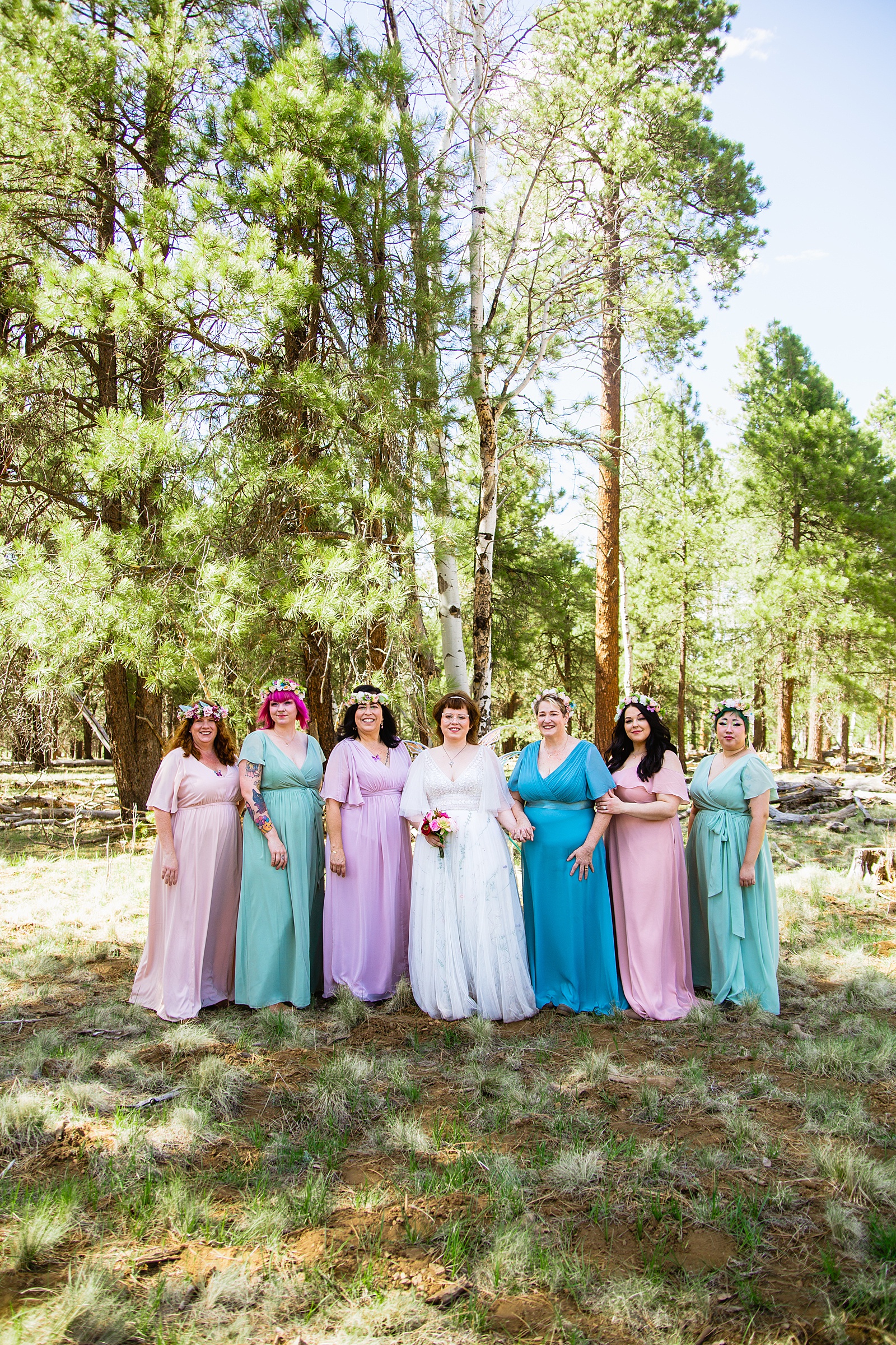 Bride and their wedding party together at a Arizona Nordic Village wedding by Arizona wedding photographer PMA Photography.