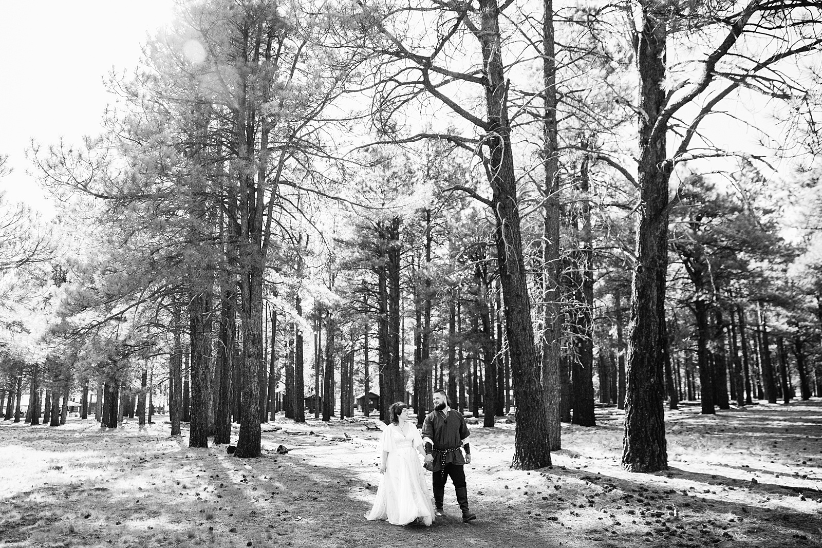 Newlyweds walking together during their Arizona Nordic Village wedding by Arizona wedding photographer PMA Photography.