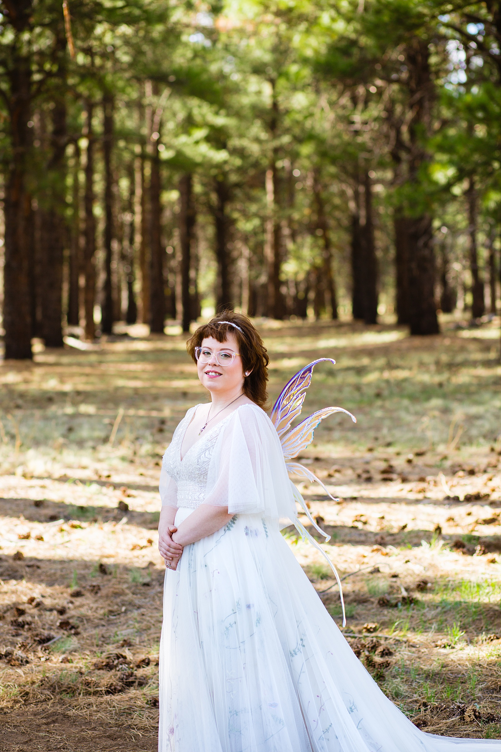 Bride at their fairy tale inspired wedding in fairy wings by Flagstaff wedding photographer PMA Photography.