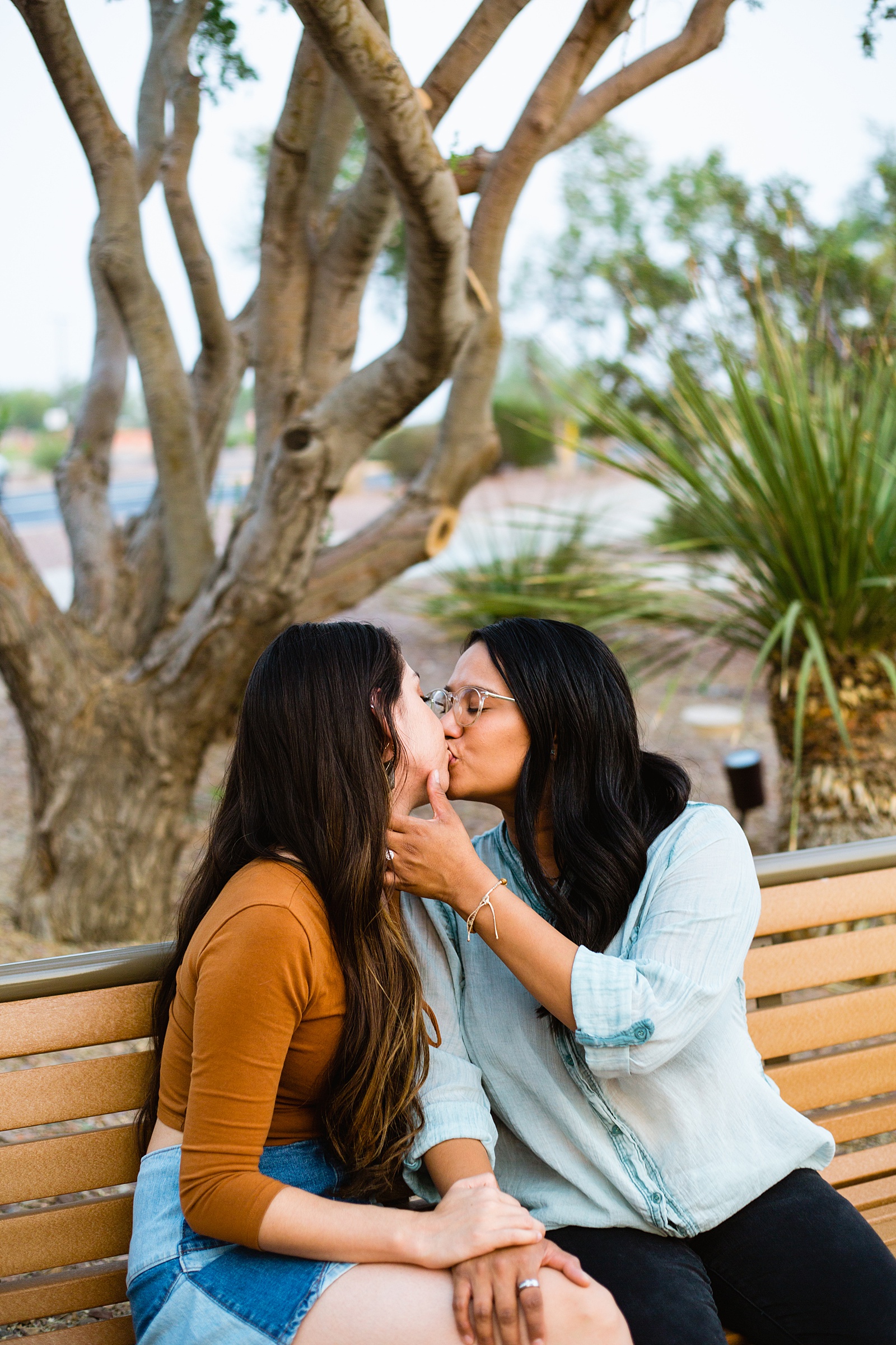 Same sex couple share a kiss during their Phoenix engagement session by Arizona wedding photographer PMA Photography.