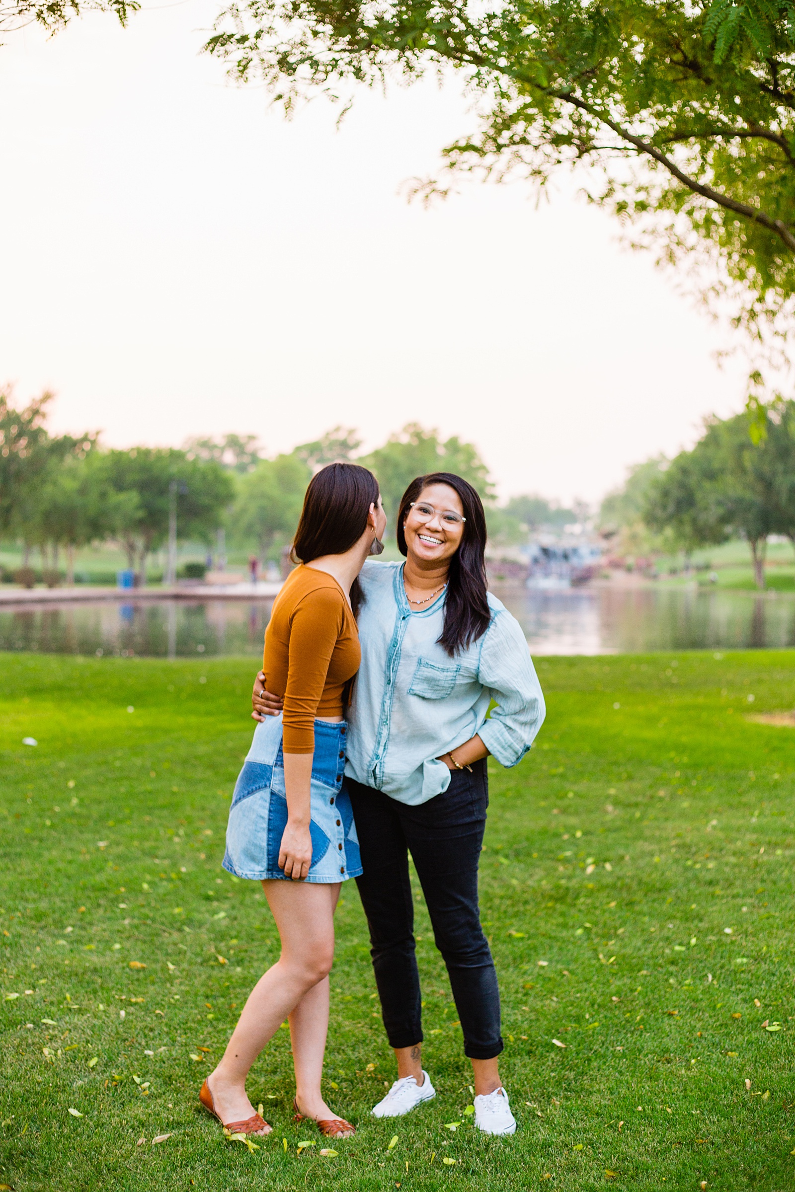 LGBTQ+ couple laugh together during their Anthem Park engagement session by Phoenix engagement photographer PMA Photography.