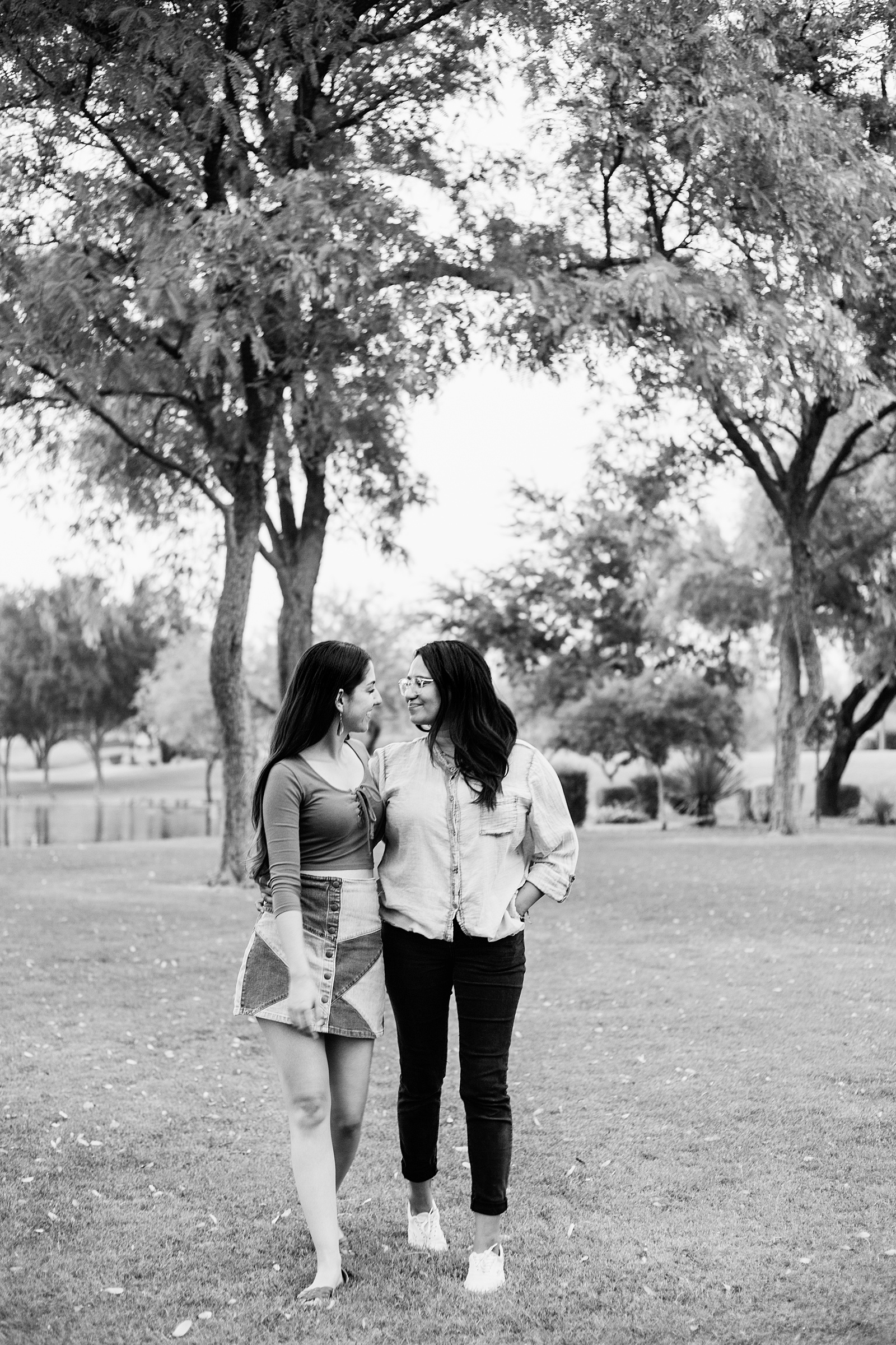 LGBTQ+ couple walking together during their Phoenix engagement session by Arizona engagement photographer PMA Photography.