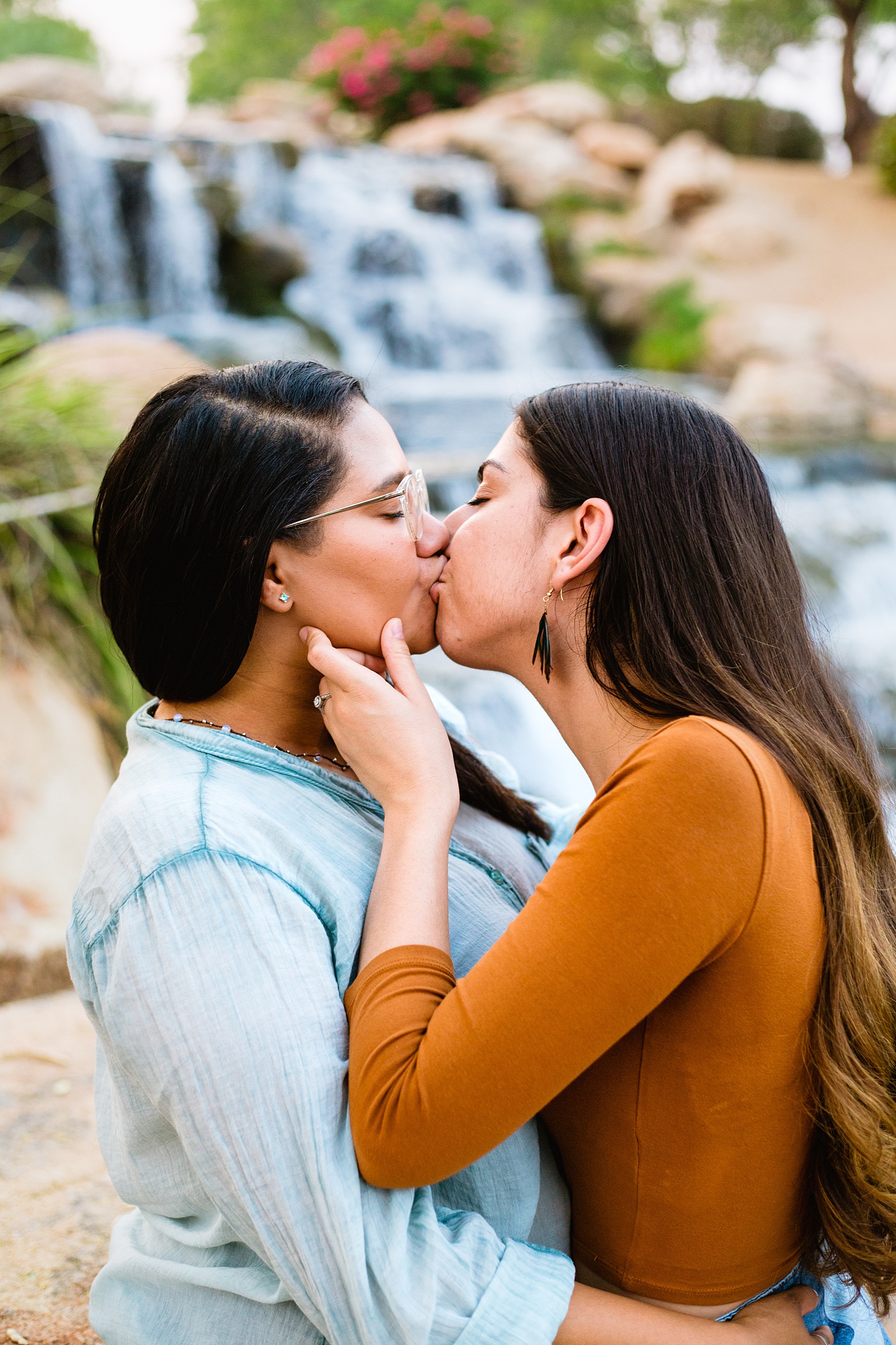 LGBTQ+ couple share a kiss during their Anthem Park engagement session by Phoenix wedding photographer PMA Photography.
