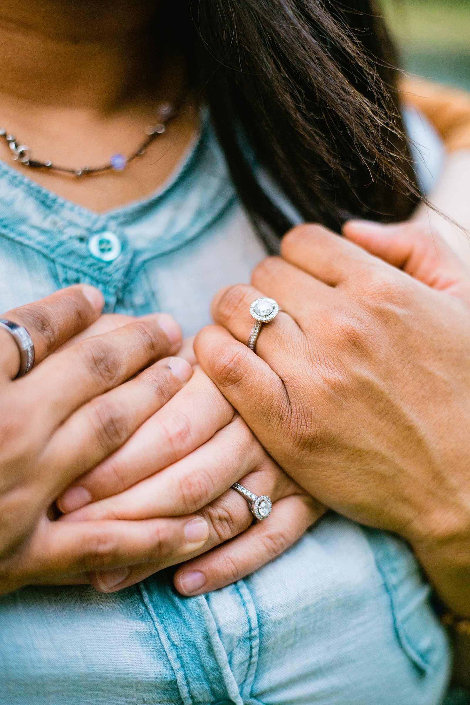 Detail image of engagement rings during during engagement session by PMA Photography.