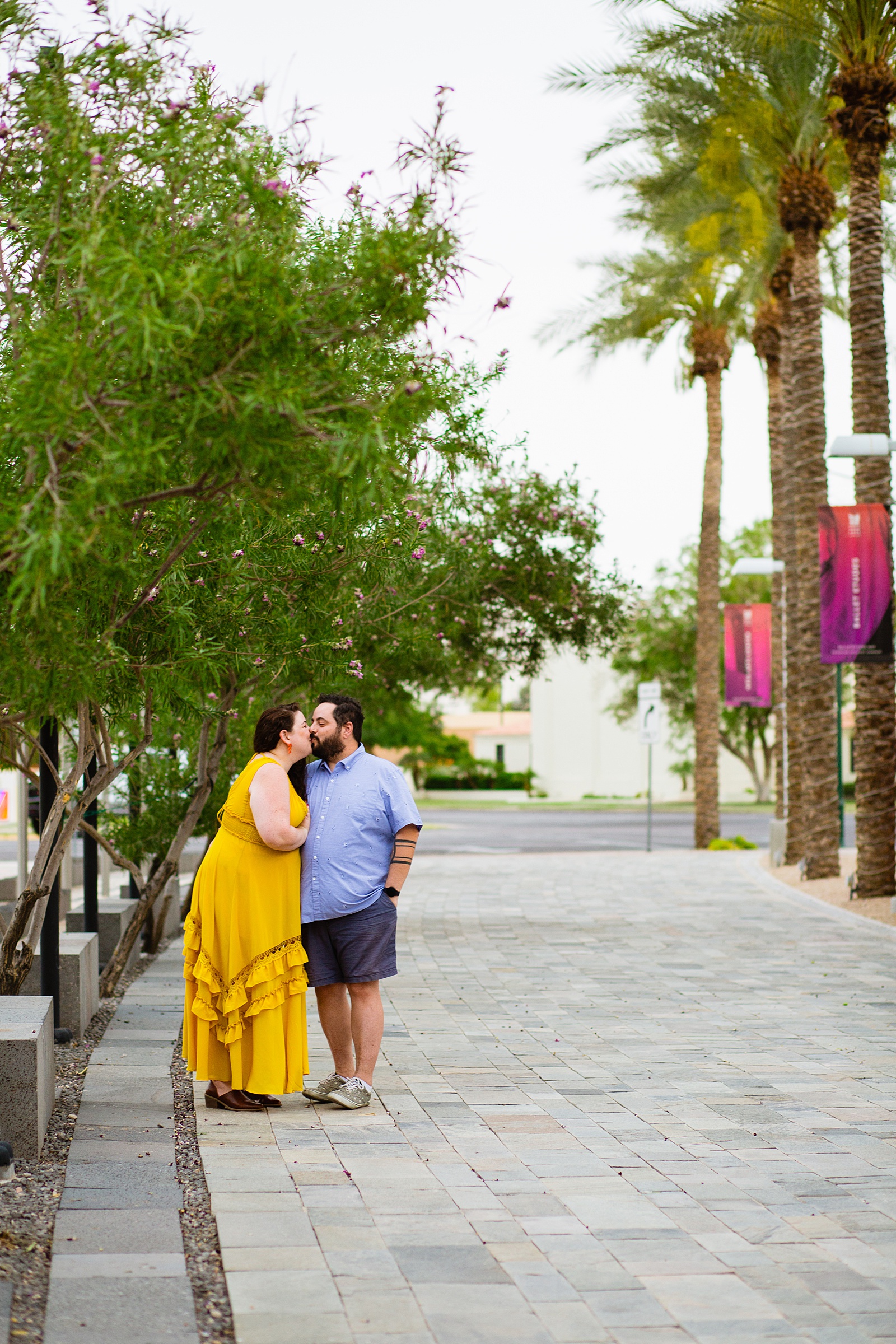 Couple share a kiss during their Mesa engagement session by Arizona wedding photographer PMA Photography.