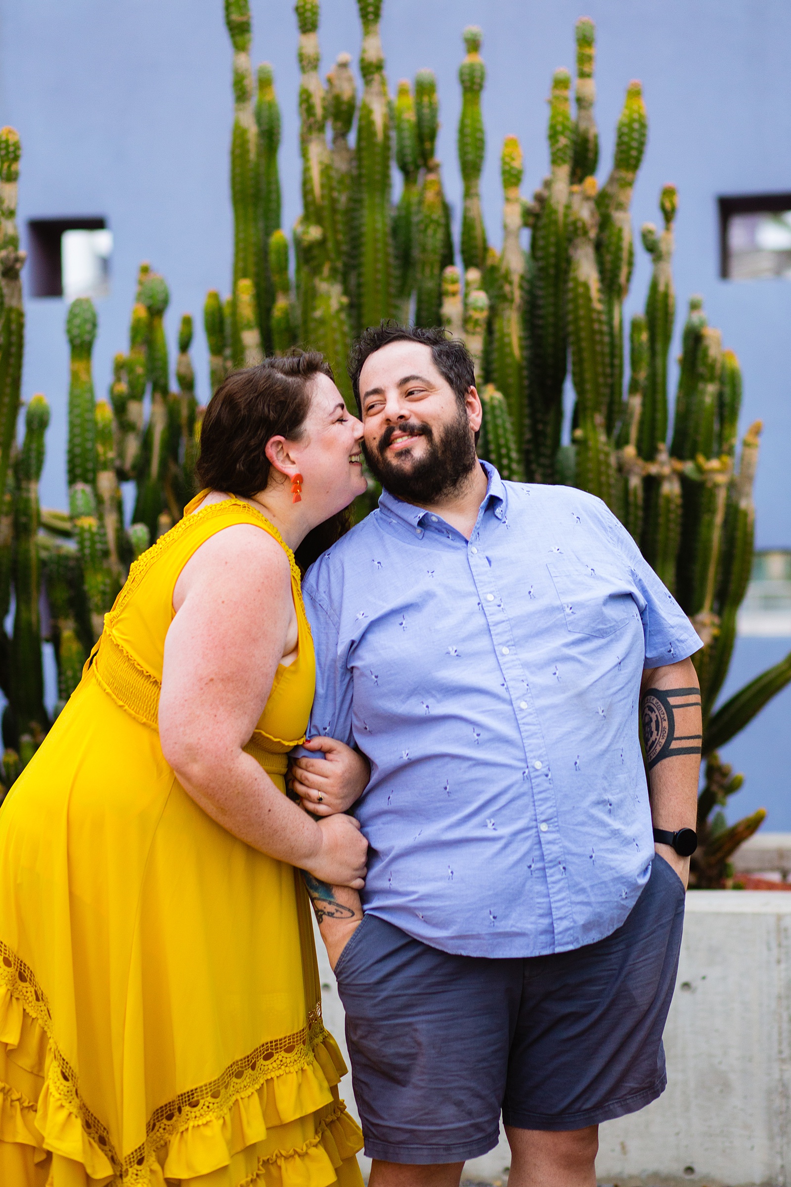 Couple share a kiss during their Mesa engagement session by Arizona wedding photographer PMA Photography.