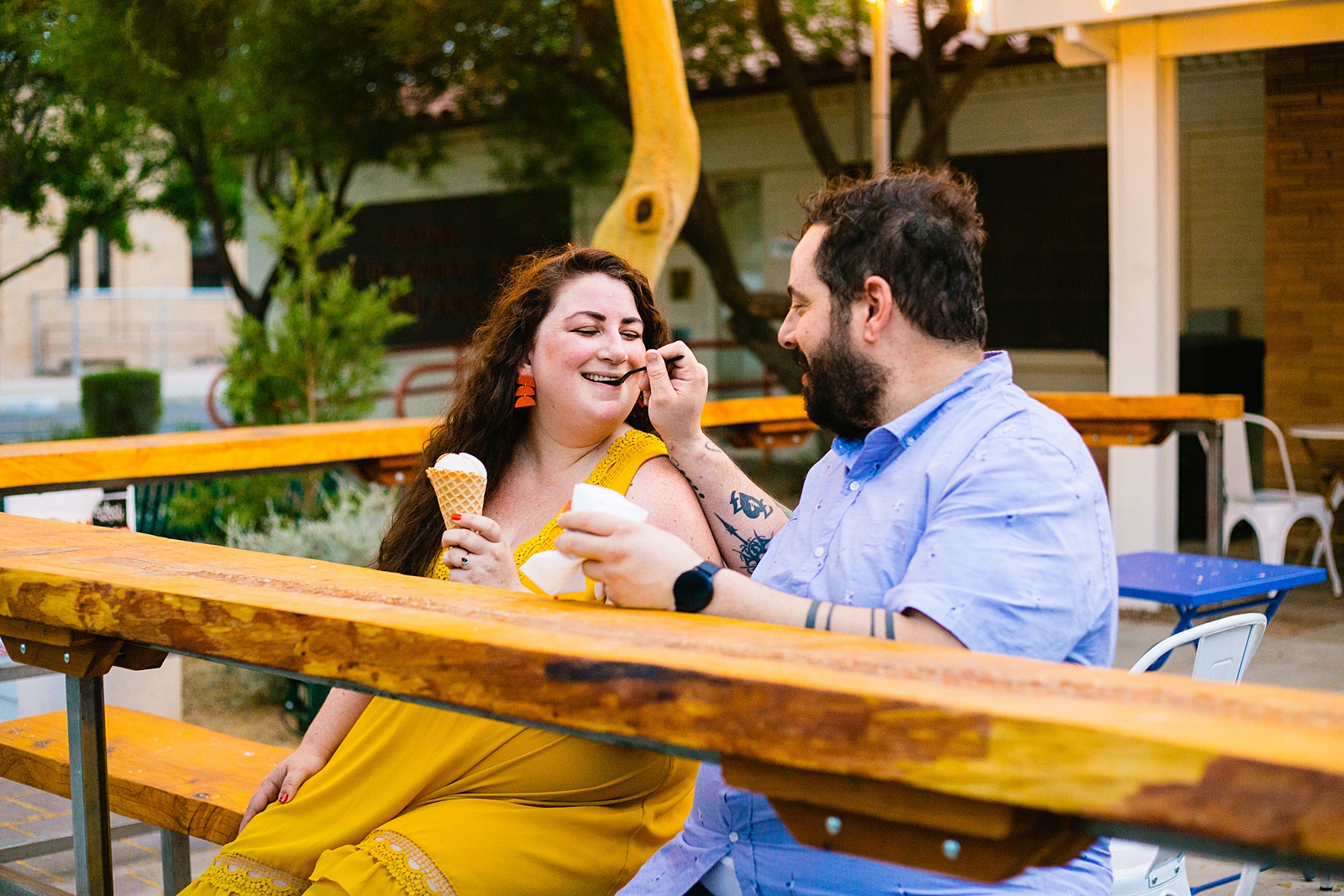 Couple share ice cream during their Mesa engagement session by Arizona wedding photographer PMA Photography.