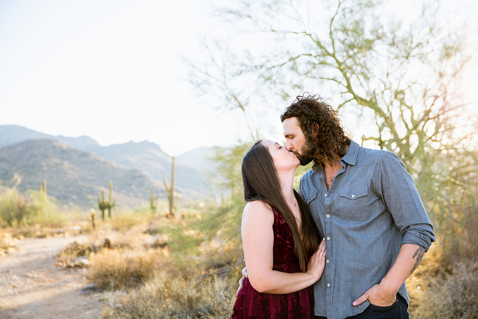 Couple share an intimate moment during their White Tanks engagement session by Phoenix engagement photographer PMA Photography.