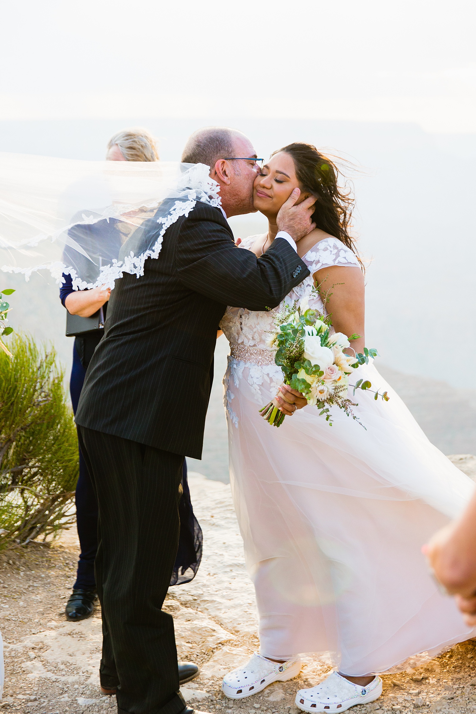 Bride sharing a moment with her father in law by Grand Canyon Elopement photographer PMA Photography.