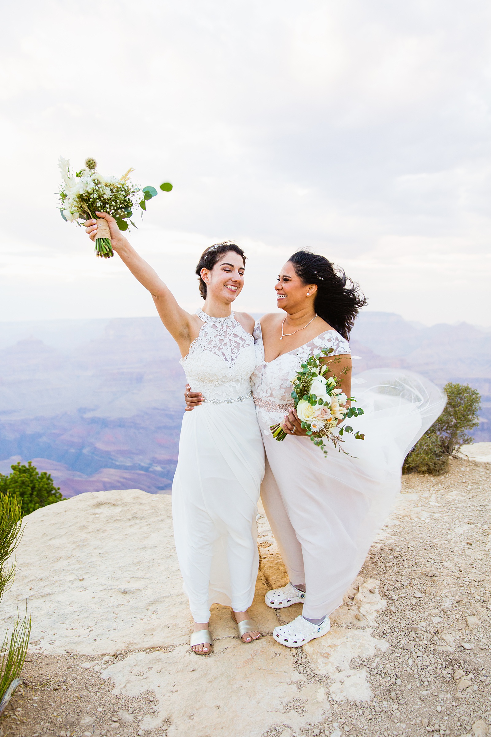Adventurous same sex couple laughing together during their Moran Point elopement by Arizona elopement photographer PMA Photography.