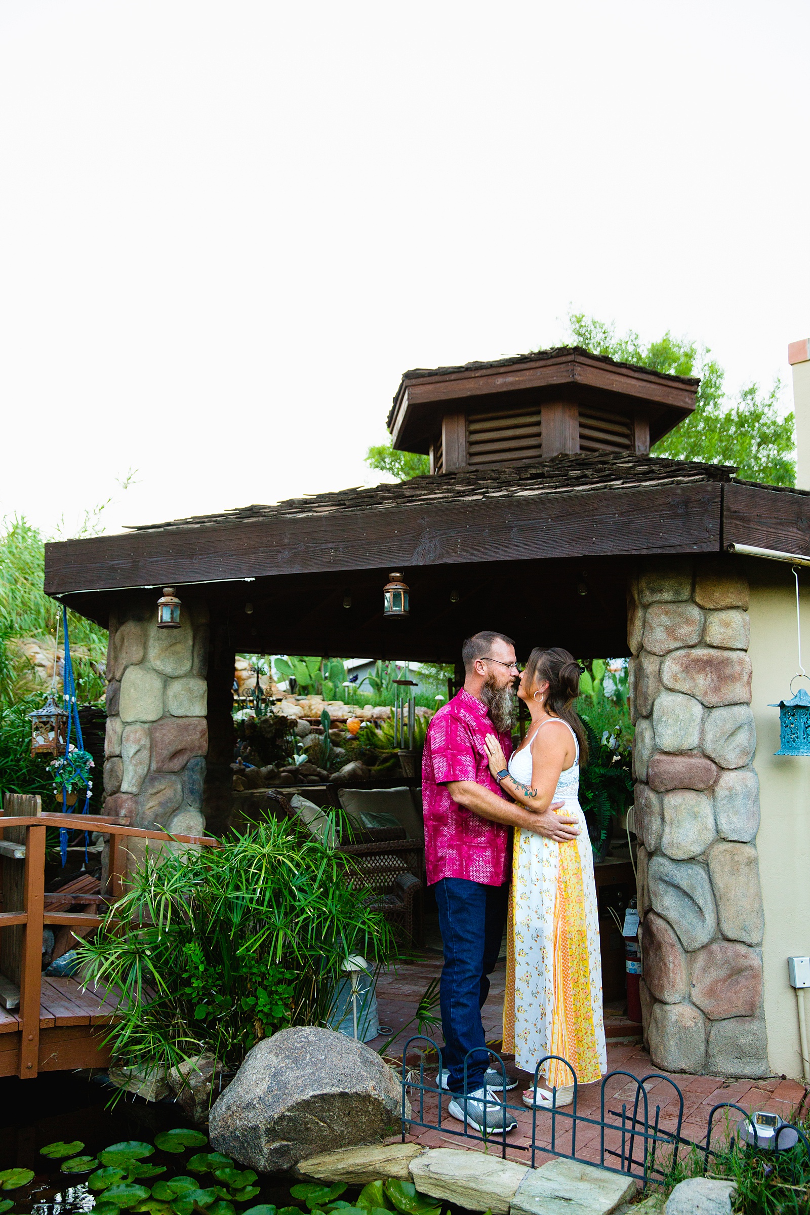 Couple share an intimate moment during their Backyard engagement session by Phoenix engagement photographer PMA Photography.