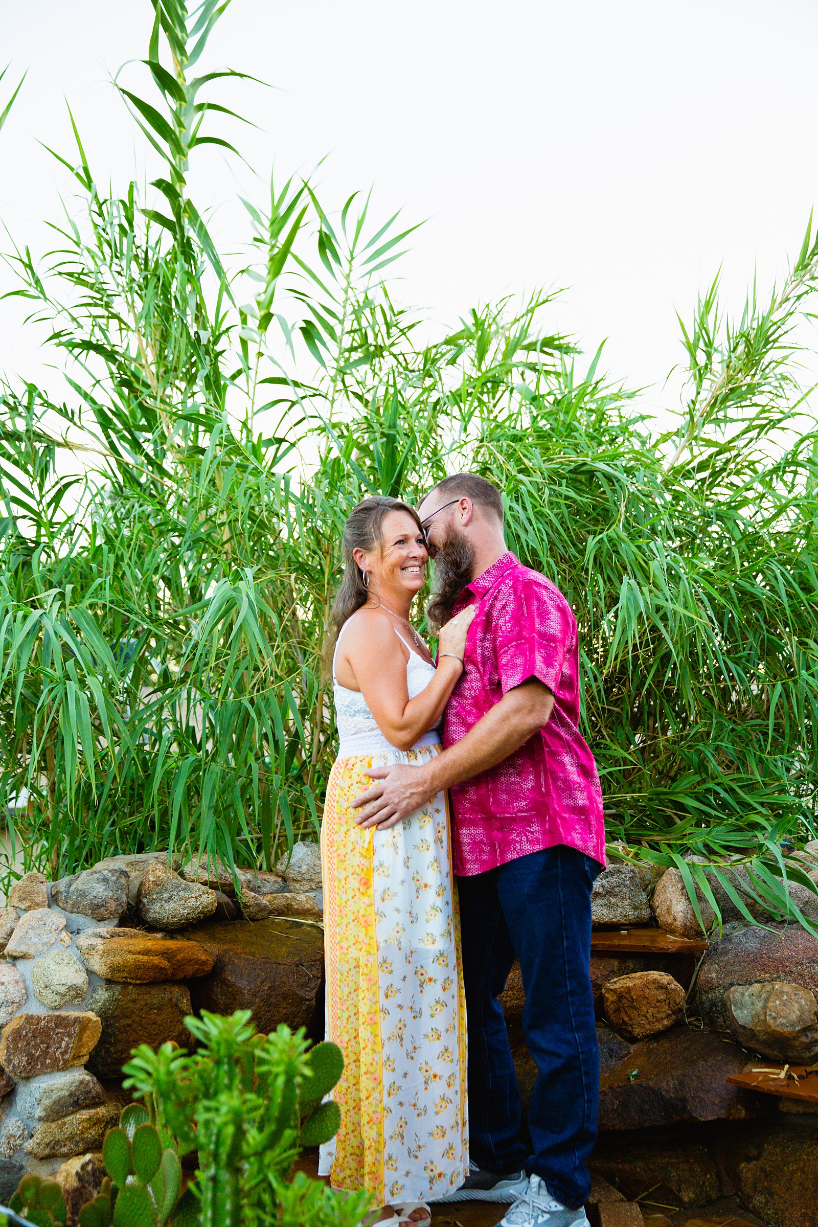 Couple laugh together during their Backyard engagement session by Phoenix engagement photographer PMA Photography.