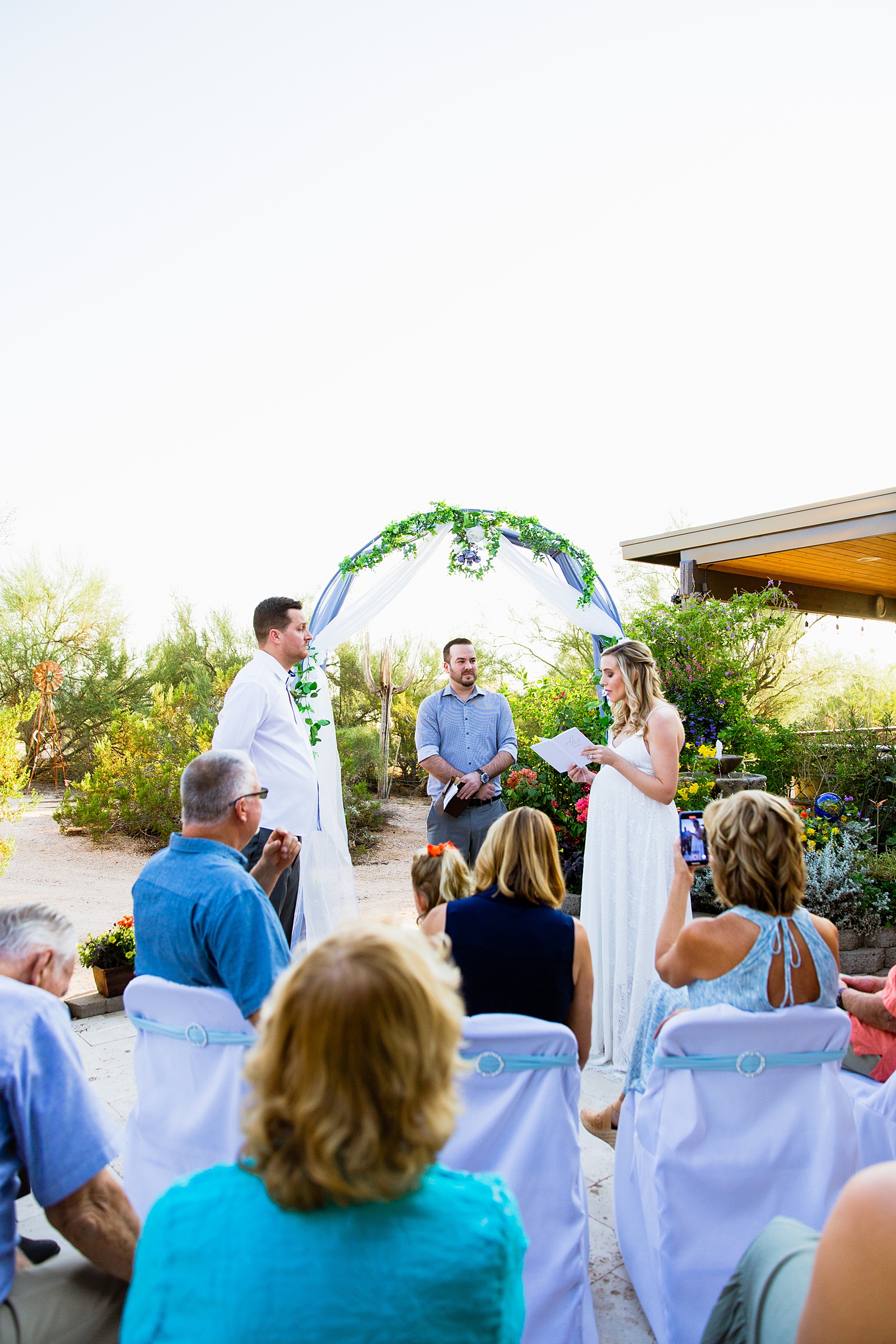 Wedding ceremony for a backyard garden elopement by Phoenix wedding photographer PMA Photography.