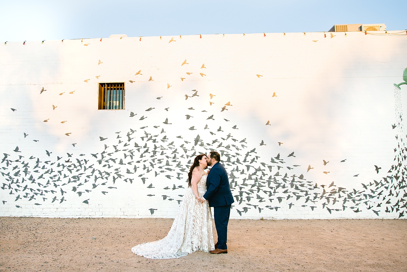 Bride and Groom share a kiss during their MonOrchid wedding by Arizona wedding photographer PMA Photography.