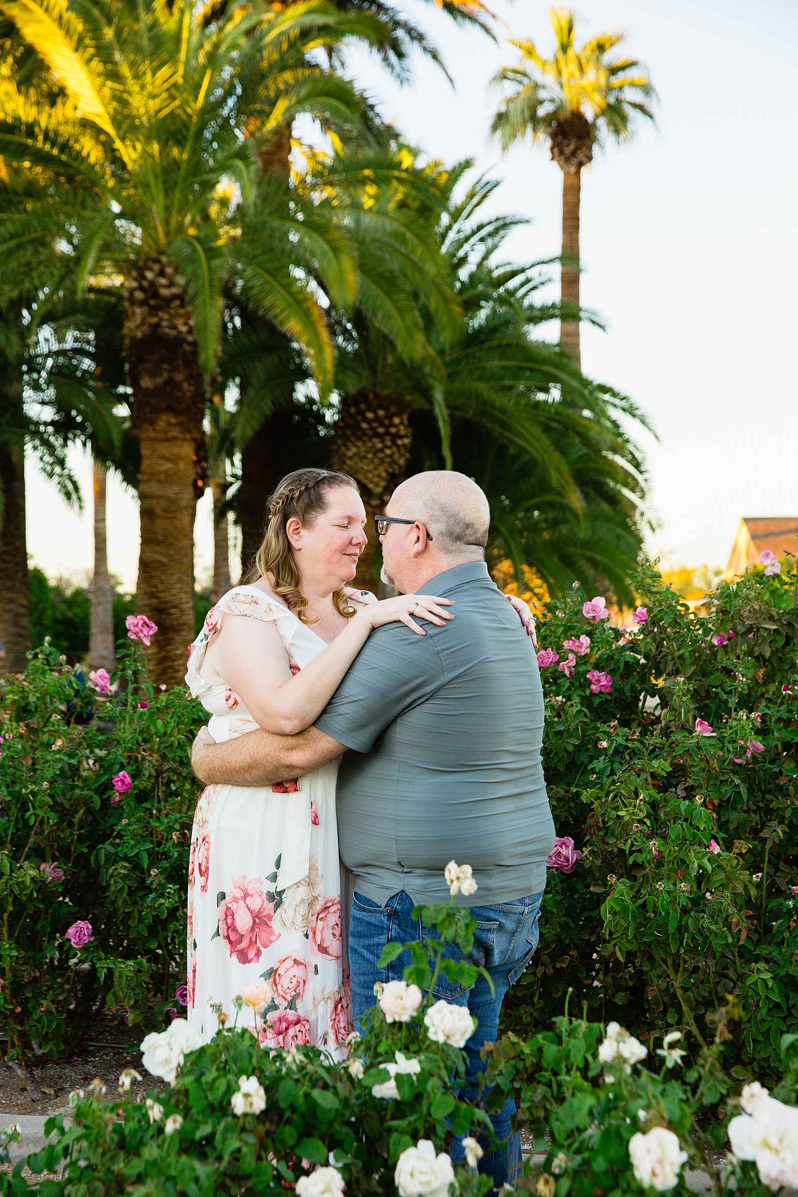 Couple look at each other during their Glendale engagement session by Arizona wedding photographer PMA Photography.