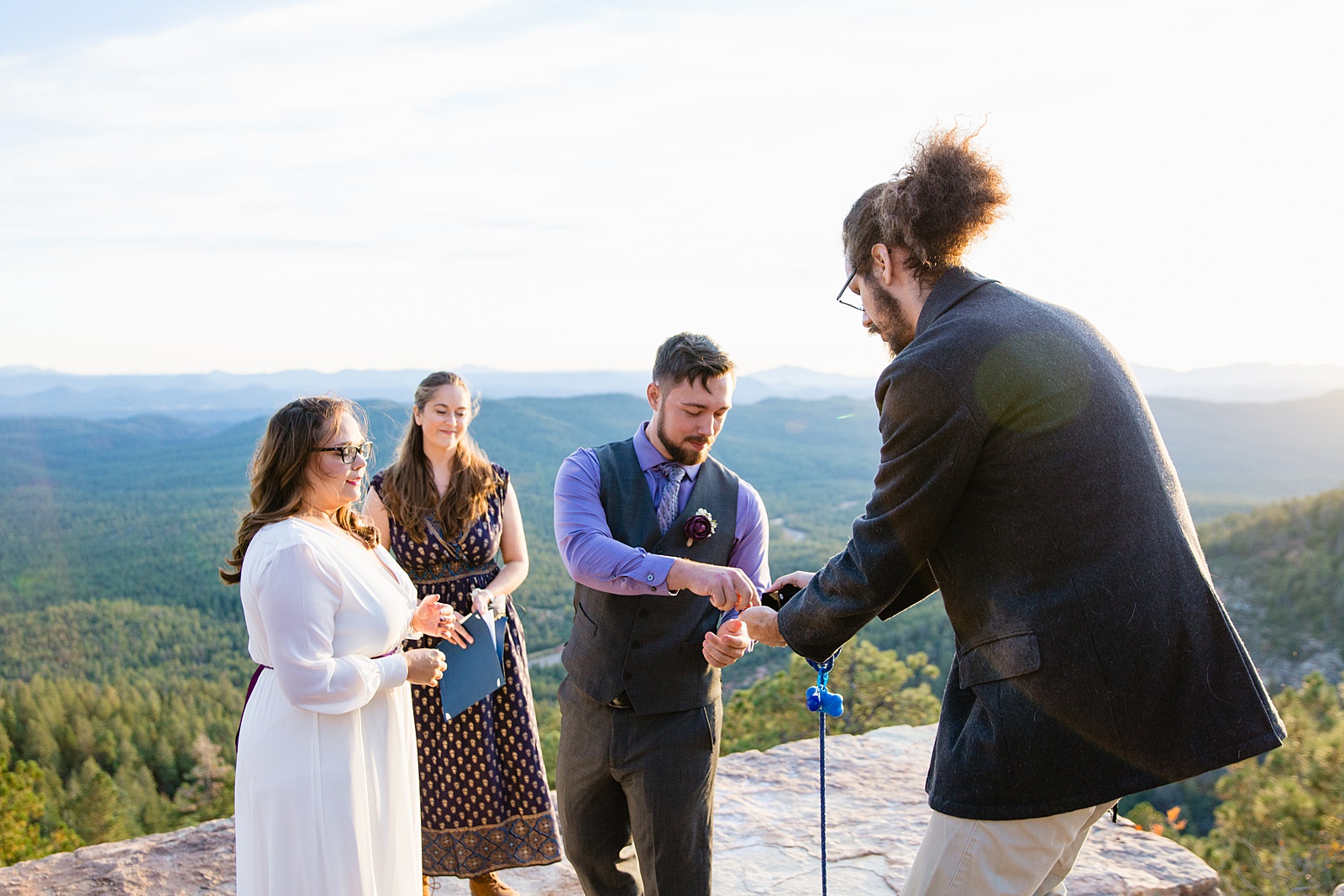 Friend gives the groom rings during a Mogollon Rim elopement by Arizona elopement photographer PMA Photography.