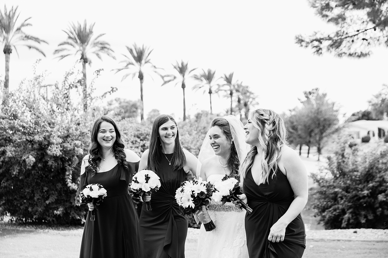 Bride and bridesmaids laughing together at Ocotillo Oasis wedding by Phoenix wedding photographer PMA Photography.