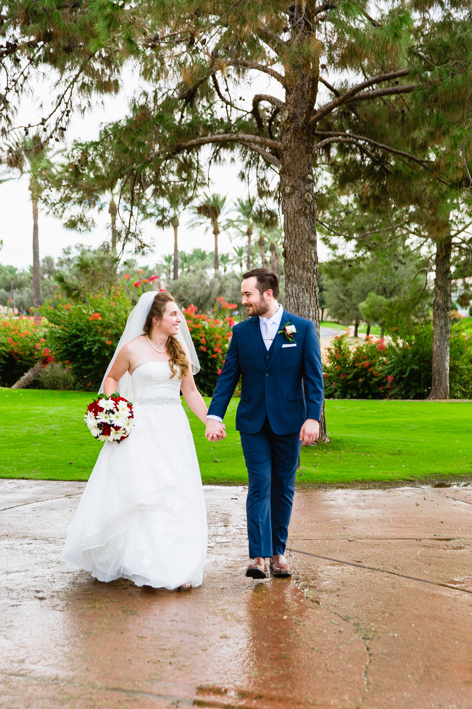 Bride and Groom walking together during their Ocotillo Oasis wedding by Arizona wedding photographer PMA Photography.