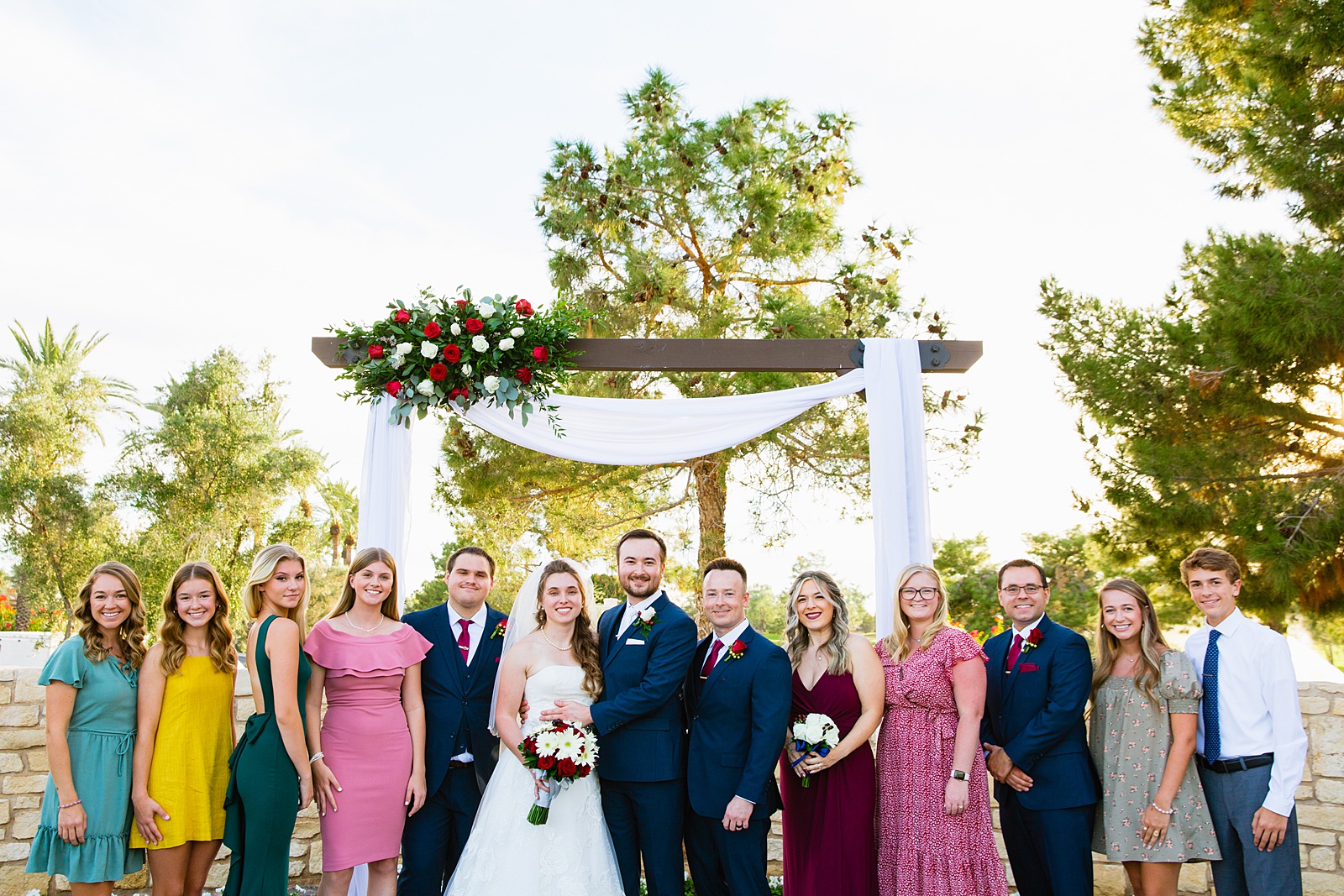 Bride and Groom pose with their families during their Ocotillo Oasis wedding by Arizona wedding photographer PMA Photography.