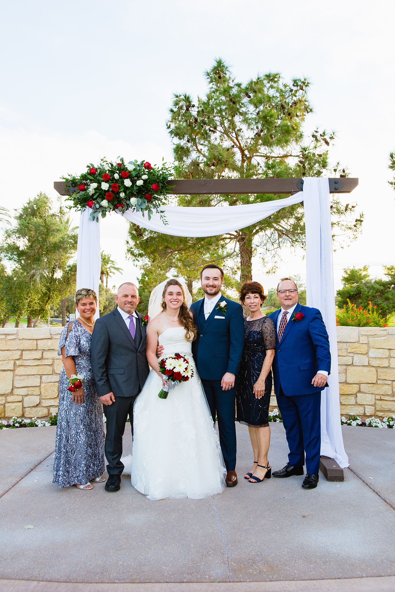 Bride and Groom pose with their families during their Ocotillo Oasis wedding by Arizona wedding photographer PMA Photography.