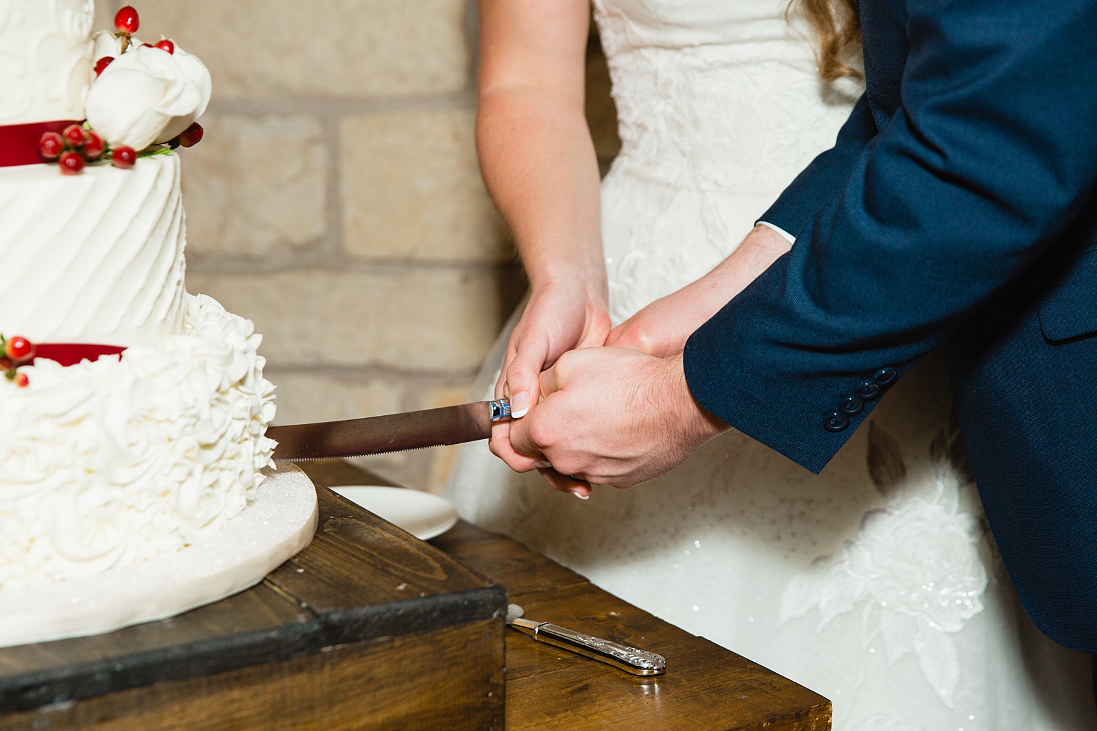 Bride and Groom cutting their wedding cake at their Ocotillo Oasis wedding reception by Arizona wedding photographer PMA Photography.