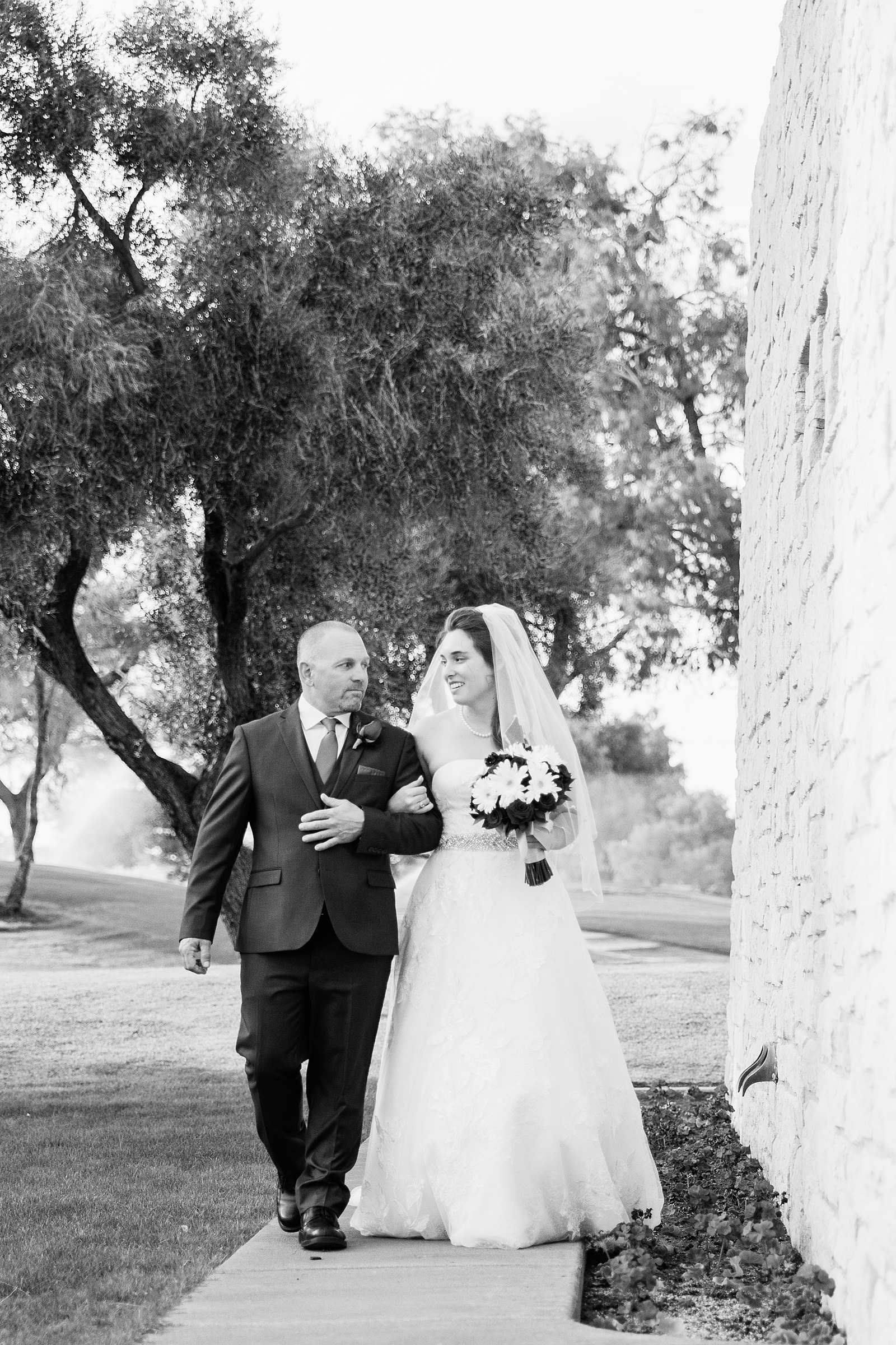Bride moments before she walks down the aisle with her father at an Ocotillo Oasis wedding ceremony by Arizona wedding photographer PMA Photography.