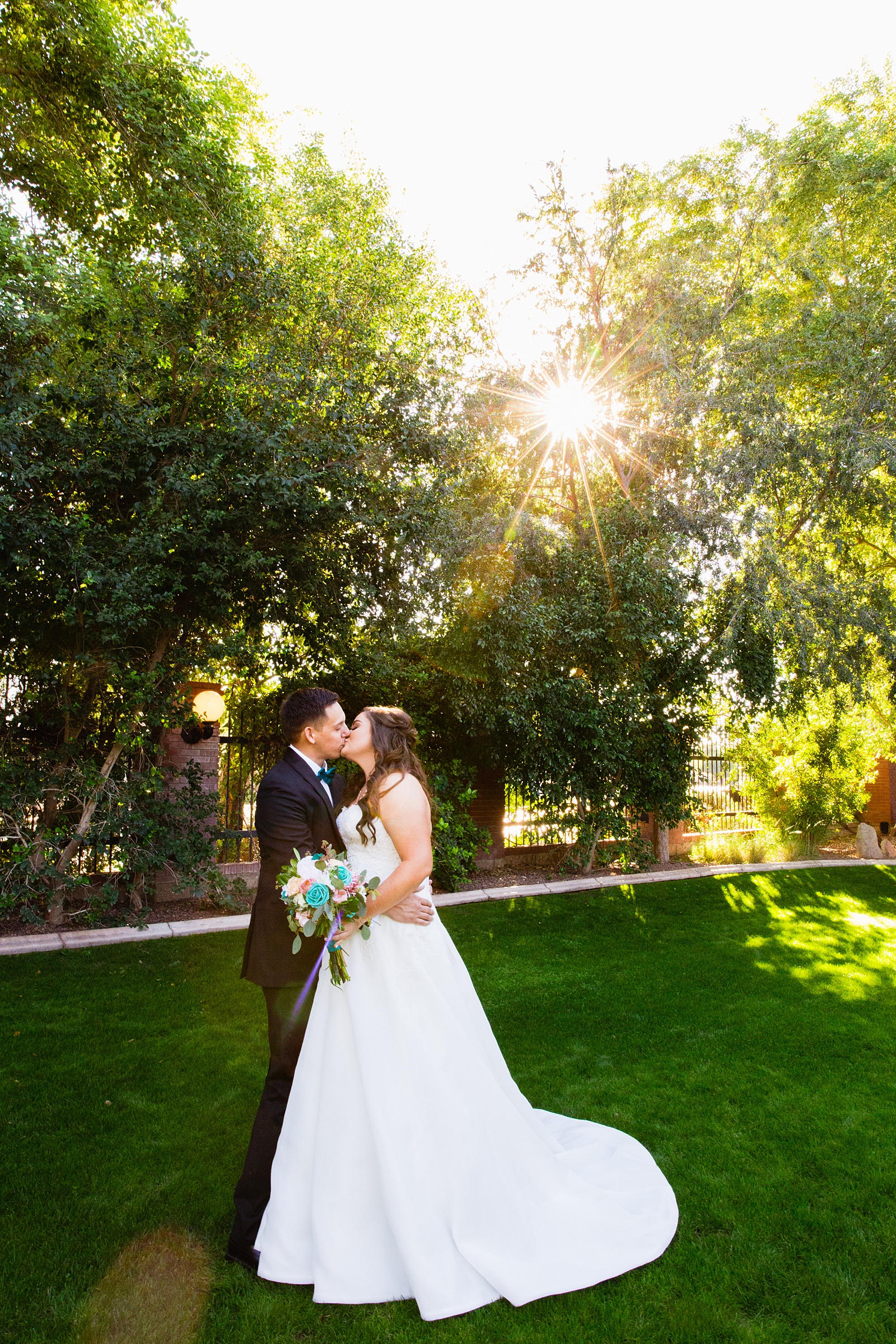 Bride and groom share a kiss during their Stonebridge Manor wedding by Arizona wedding photographer PMA Photography.